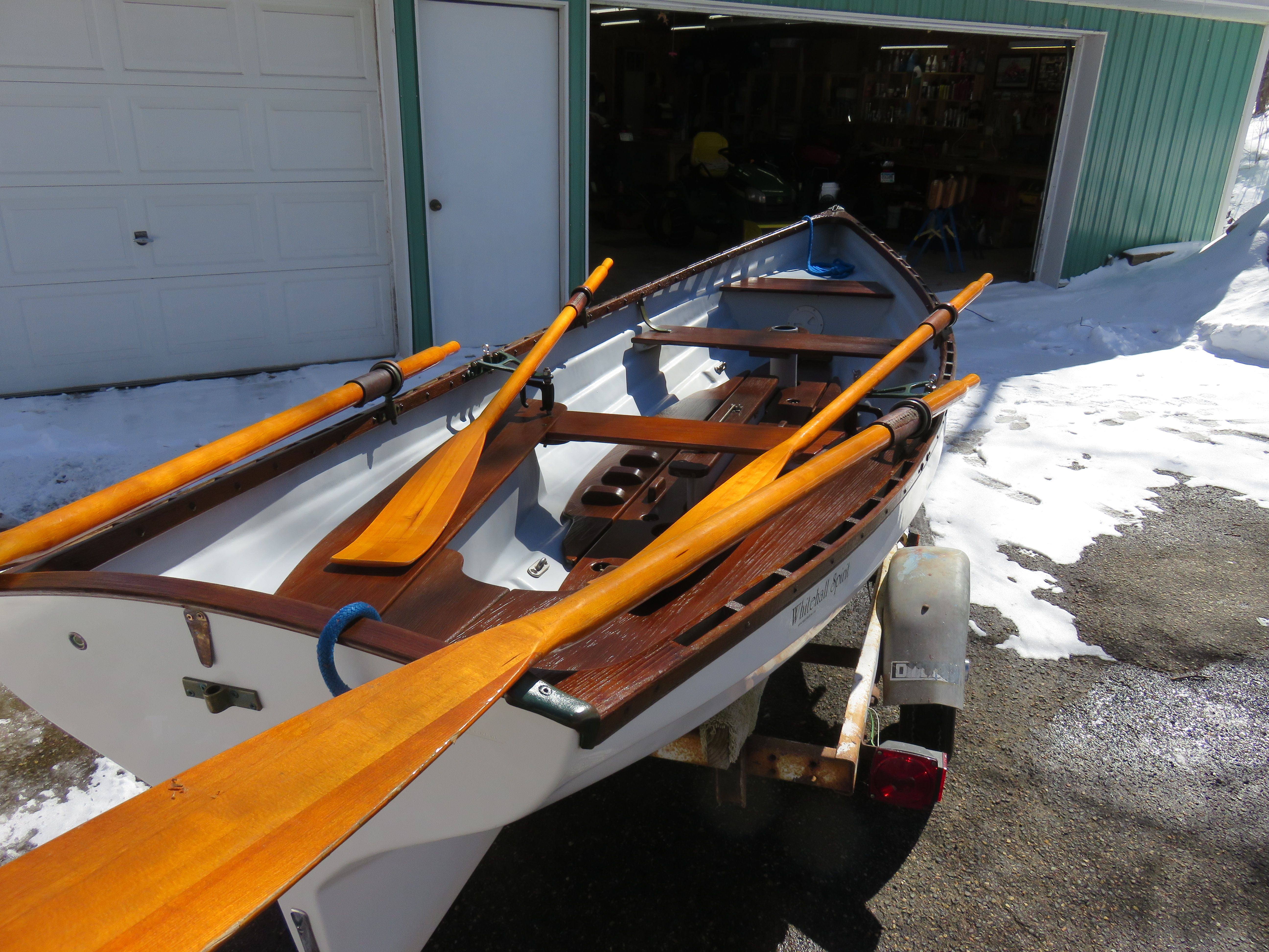 A 2005 Whitehall Spirit 14 rowboat on a trailer, surrounded by snow.