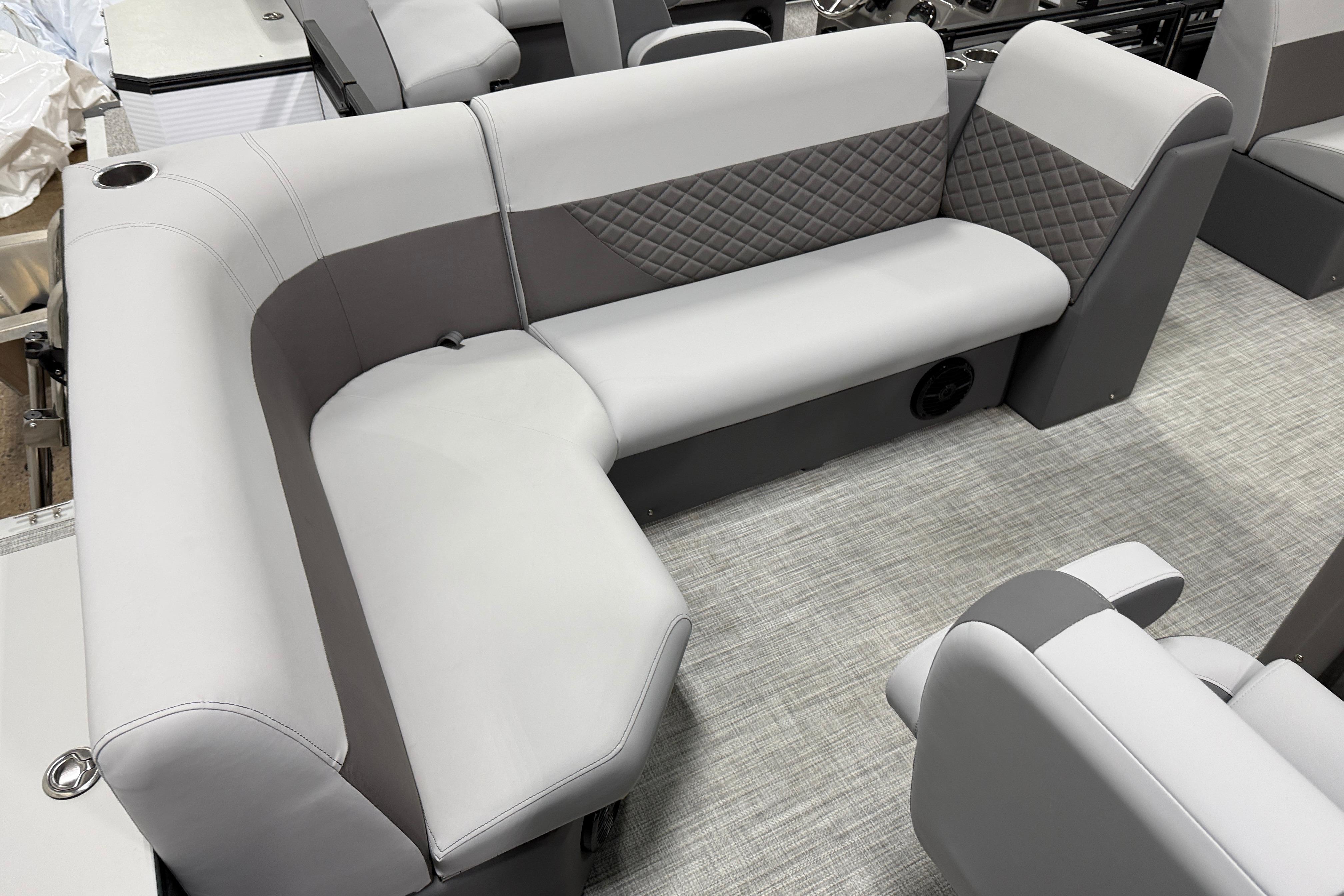 2026 Angler Quest 818 Panfish Cruise boat interior with gray seating and quilted accents.
