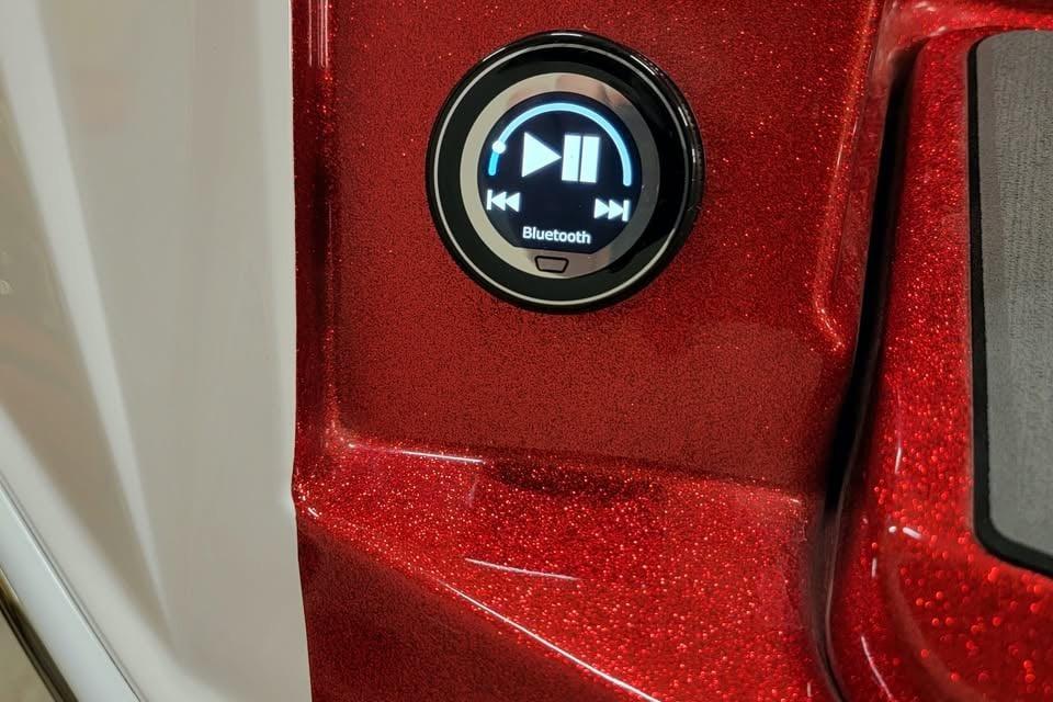 2023 Supra SE 550 Bluetooth control on sparkling red dashboard.