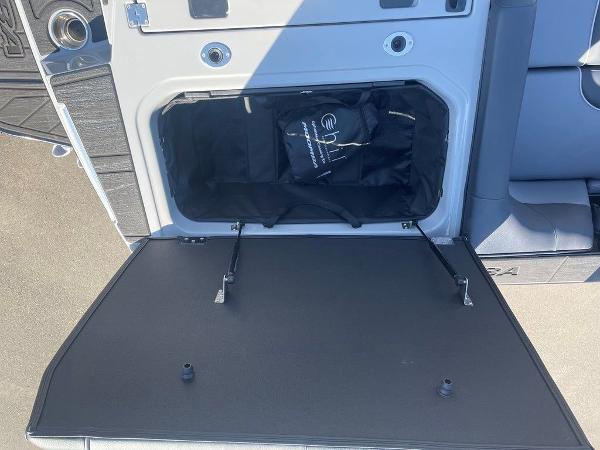 Open storage compartment in a 2025 Moomba Mondo boat, showcasing interior space.