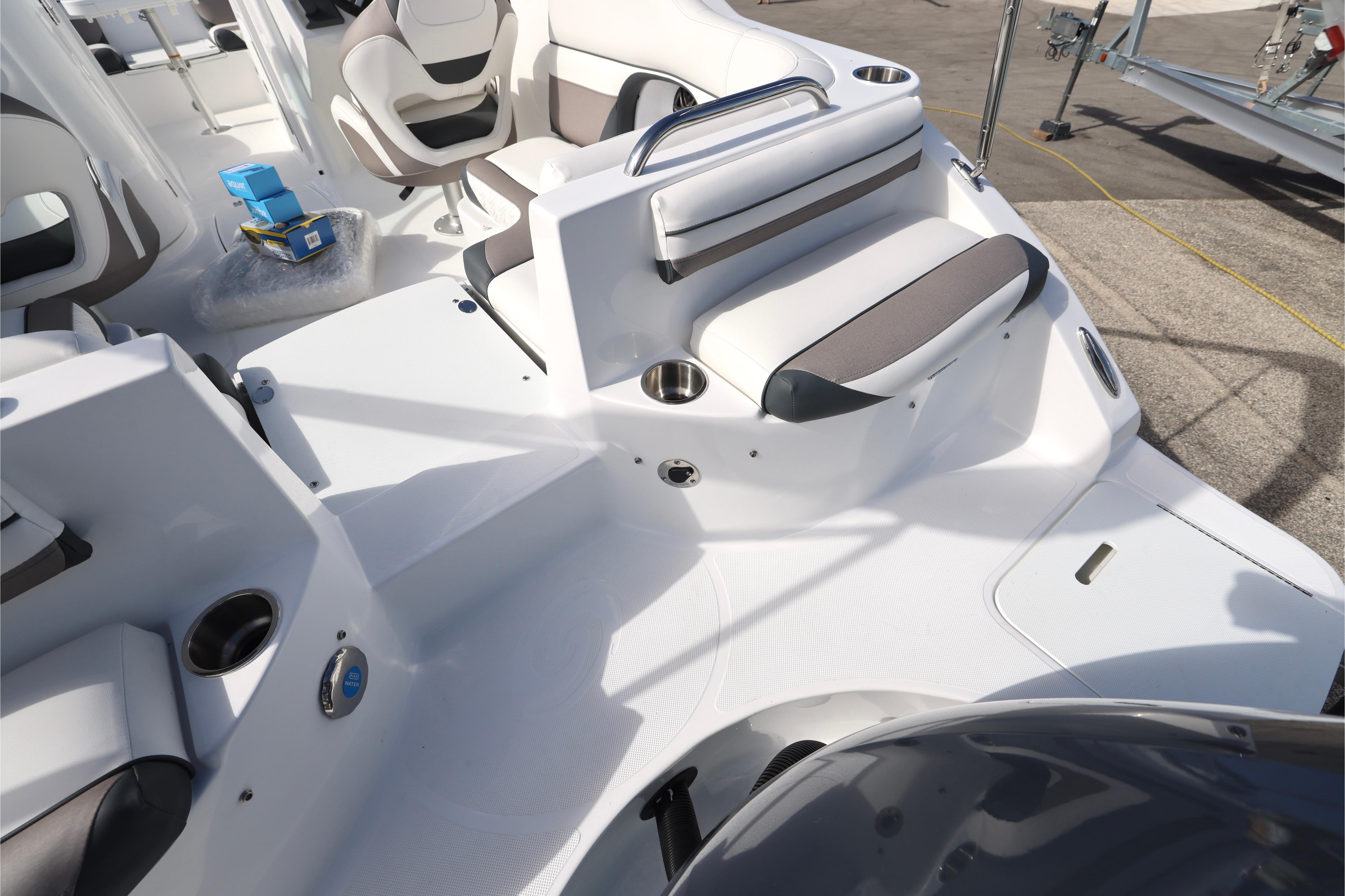 2026 Hurricane SunDeck 2486 OB boat interior with seating and cup holders.