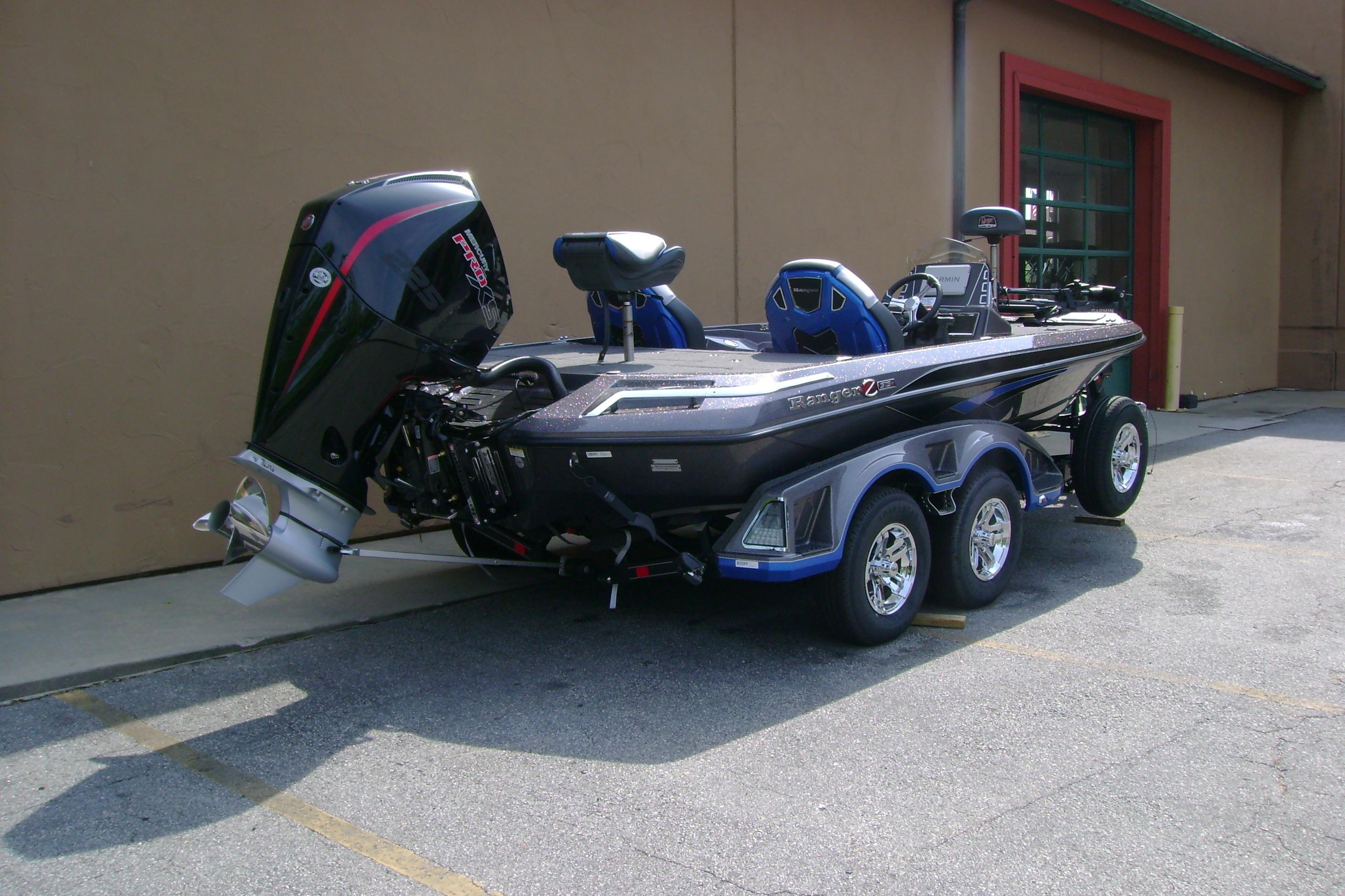 2026 Ranger Z519R Cup-Equipped boat with powerful outboard motor, parked outdoors.