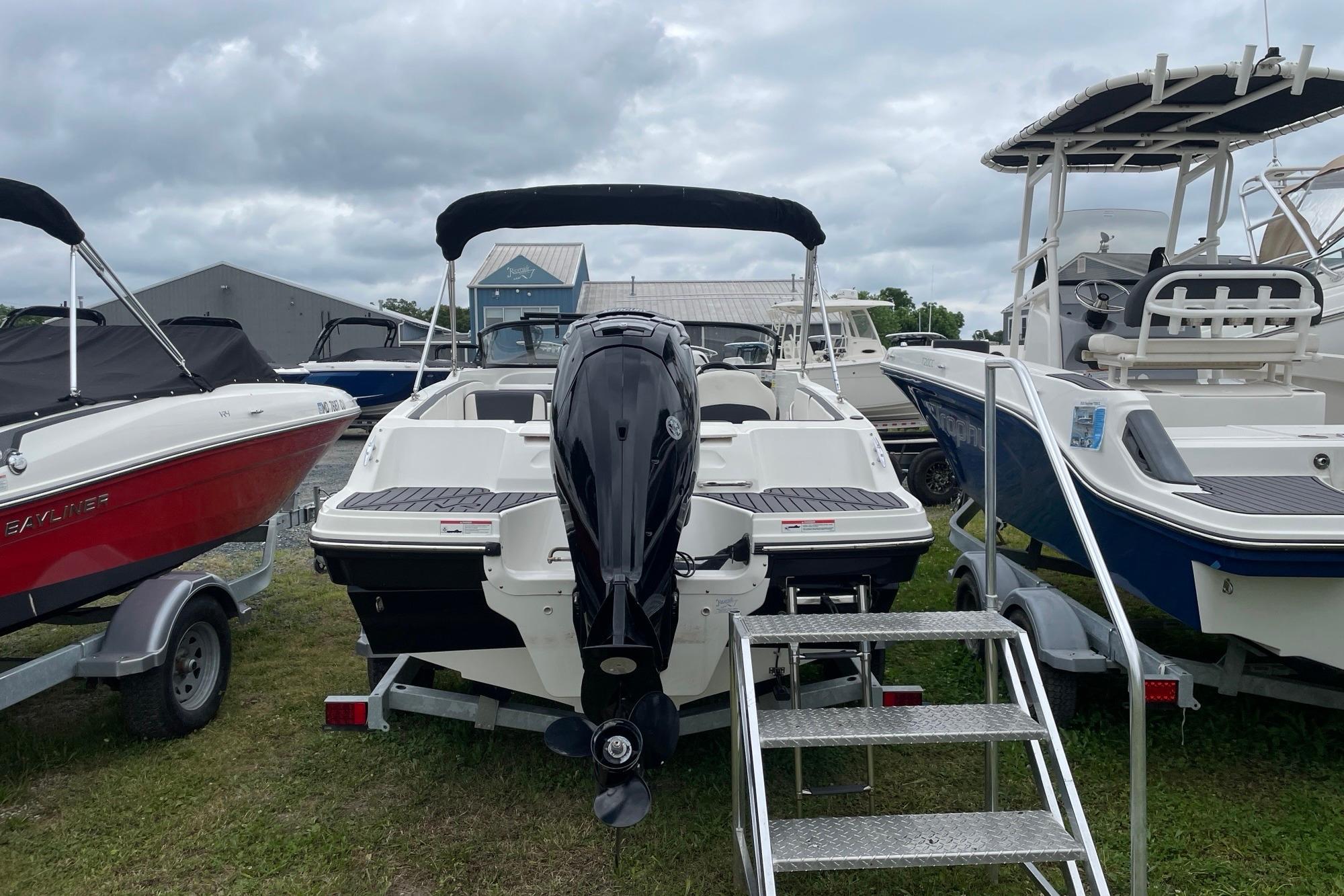 2023 Bayliner VR4 Bowrider OB with outboard motor, displayed among other boats.