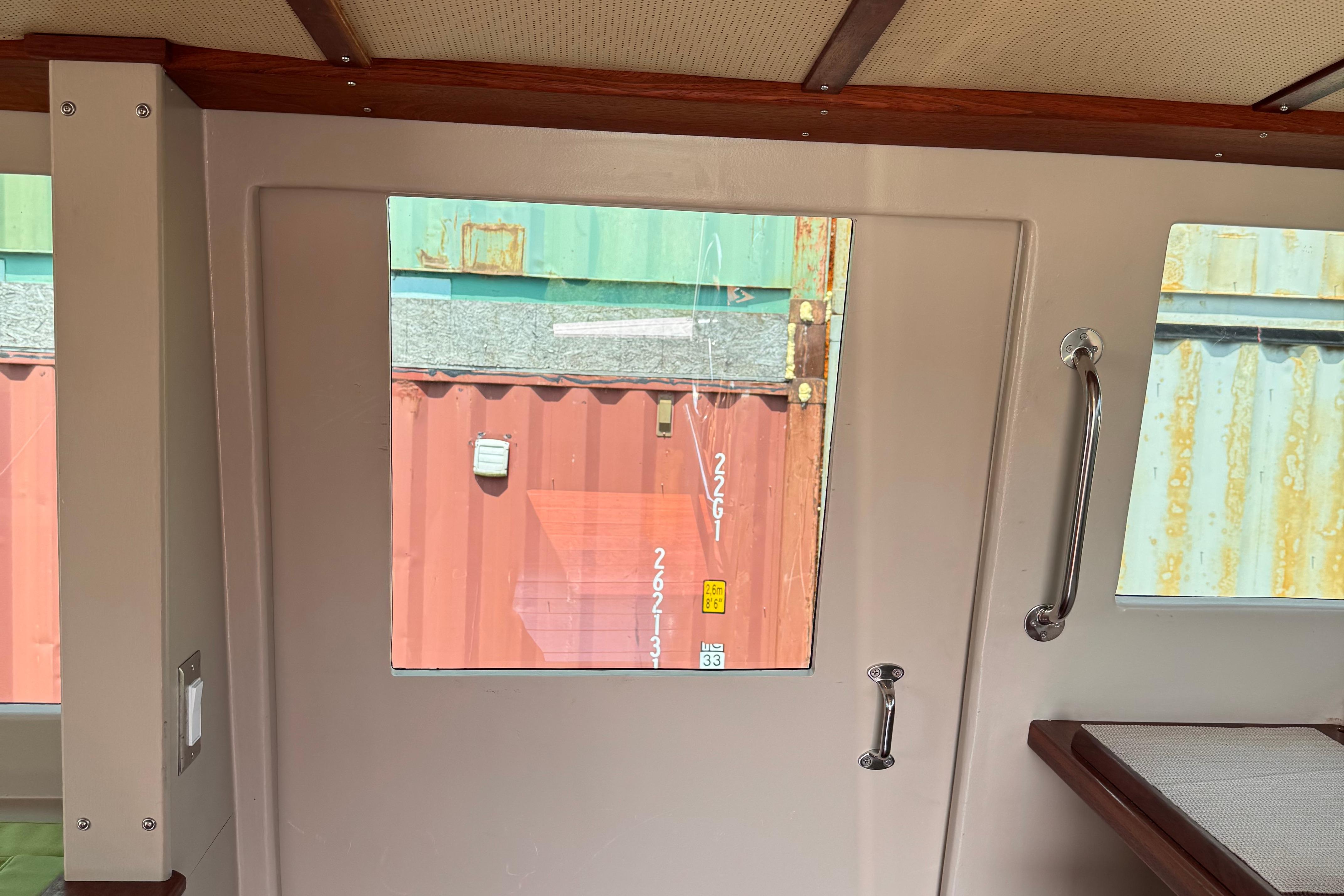 Interior view of 2021 Trawler Cape Island Cruisers Cape Sable, featuring window and door handle.