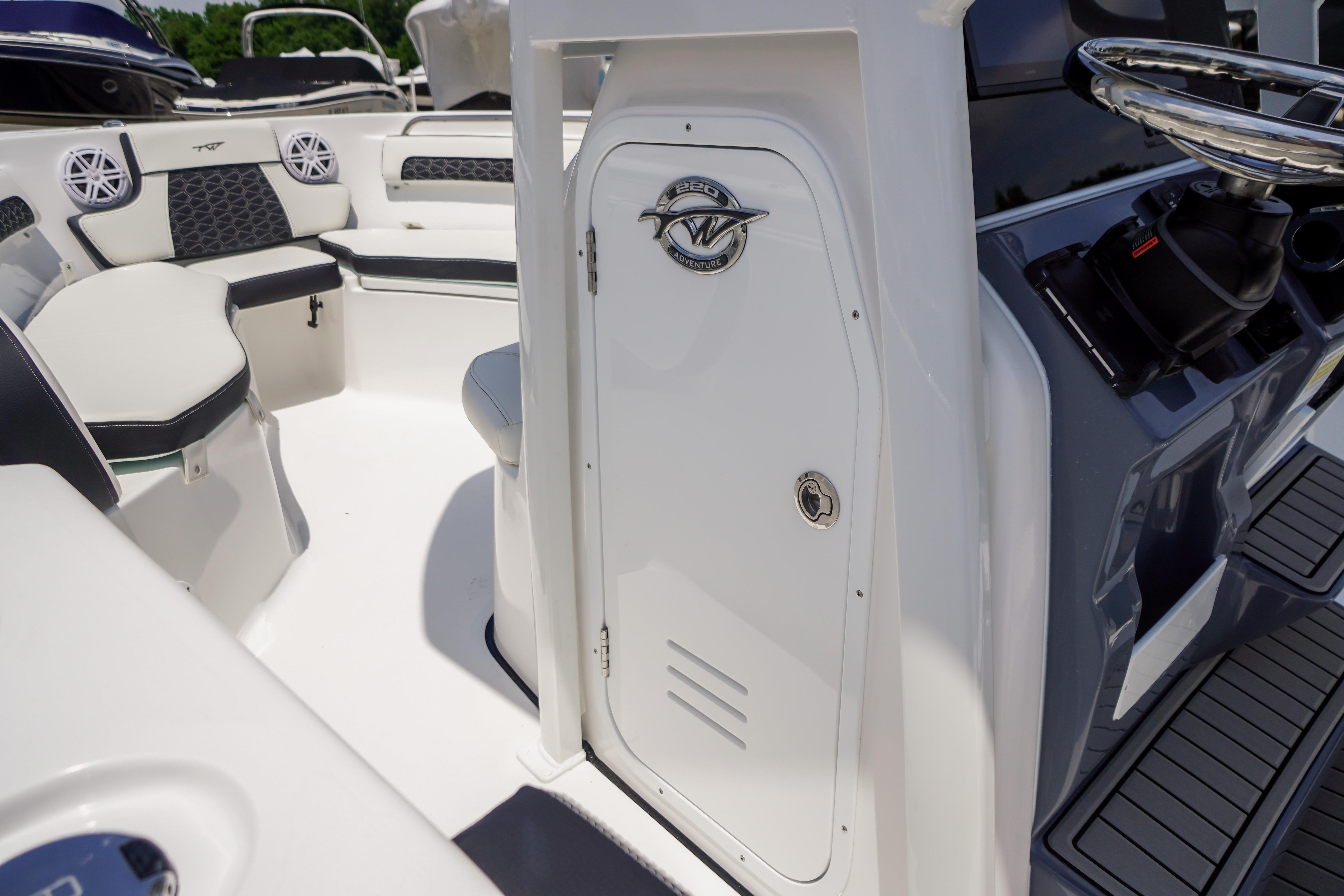 2027 Tidewater 220 CC Adventure boat interior with seating and steering console.