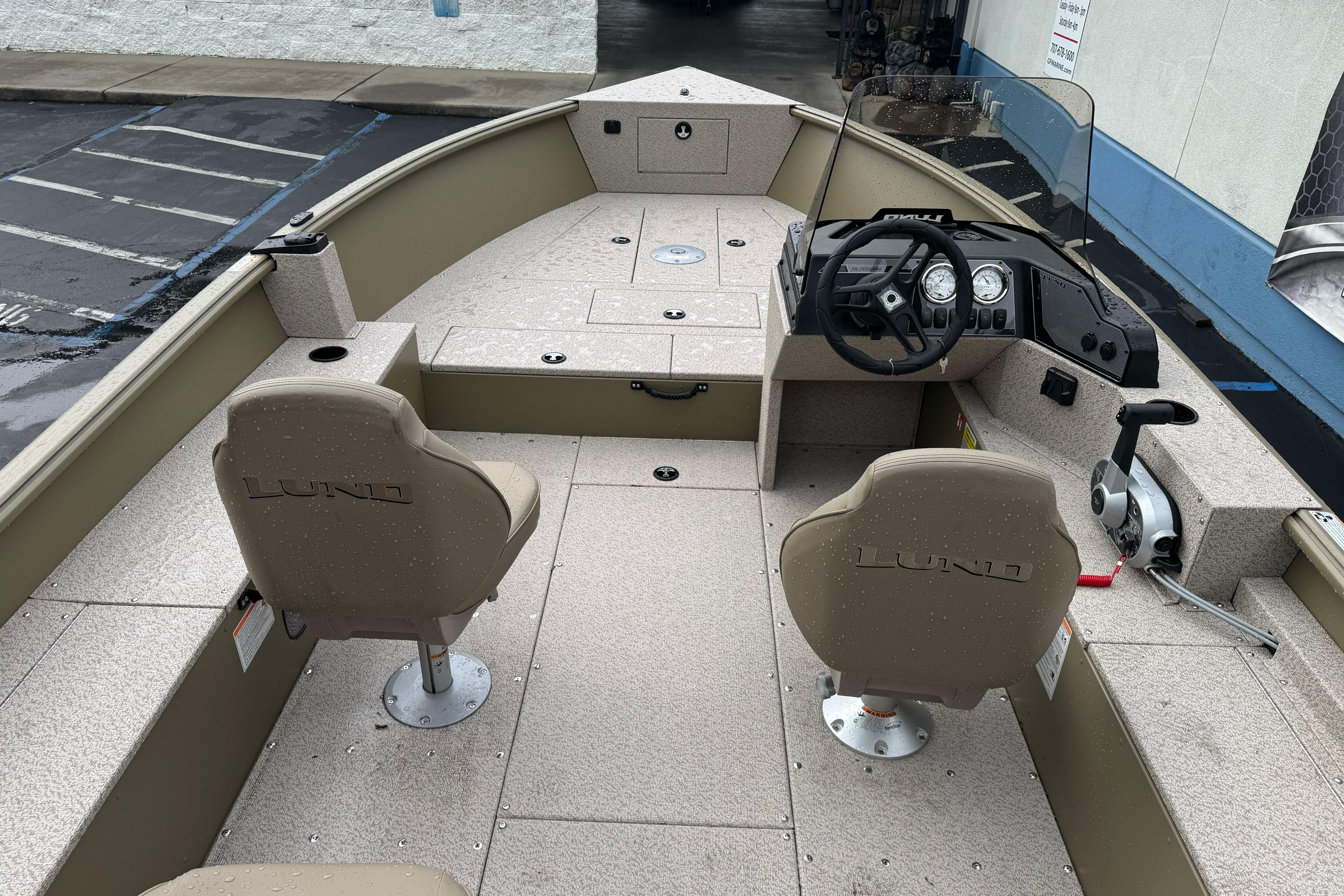 2026 Lund 2075 Alaskan SS boat interior with steering console and seating.