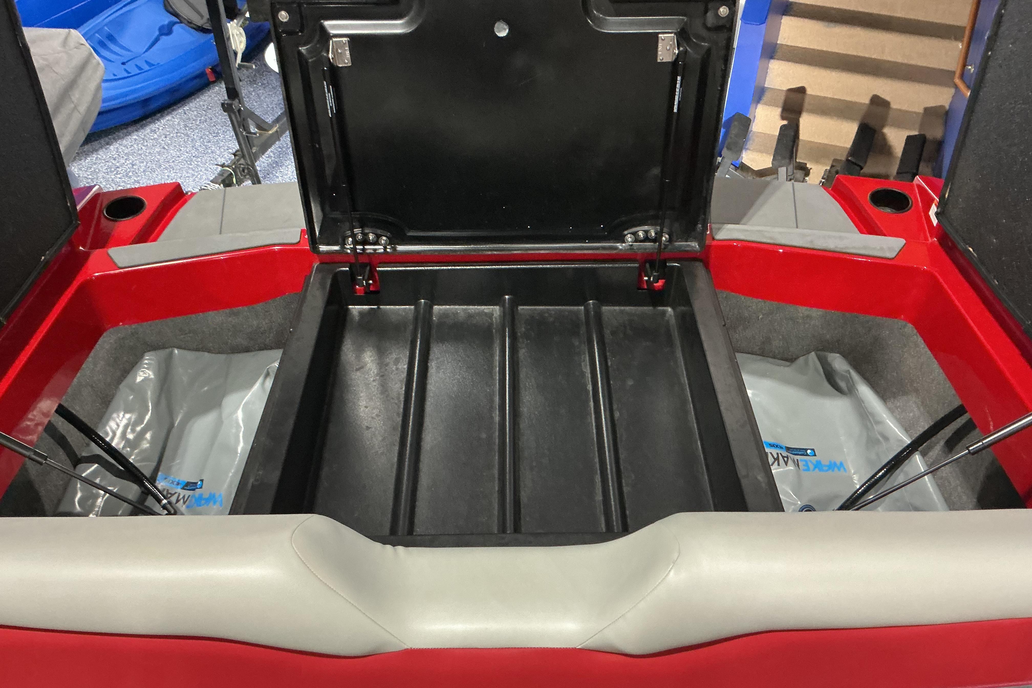 Open storage compartment of 2022 Axis T250 boat, showcasing interior space and design.