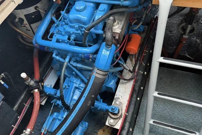 Engine compartment of a 1982 Lancer 45 Motorsailer, featuring a blue-painted engine.