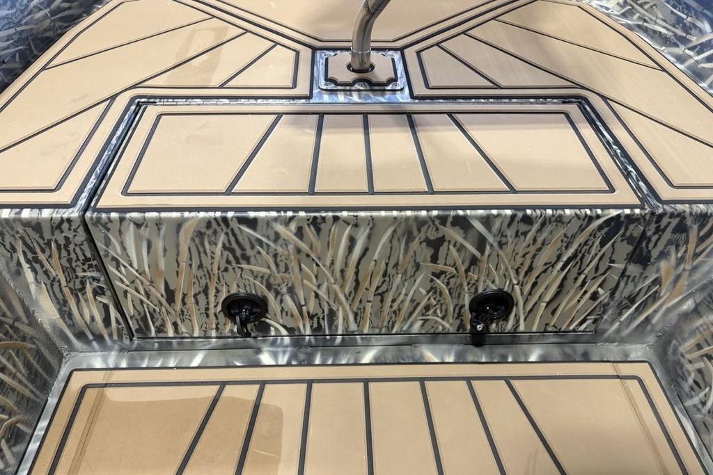 2026 Tracker Grizzly 1650 T Prairie Wings Edition boat interior with camo design and tan flooring.