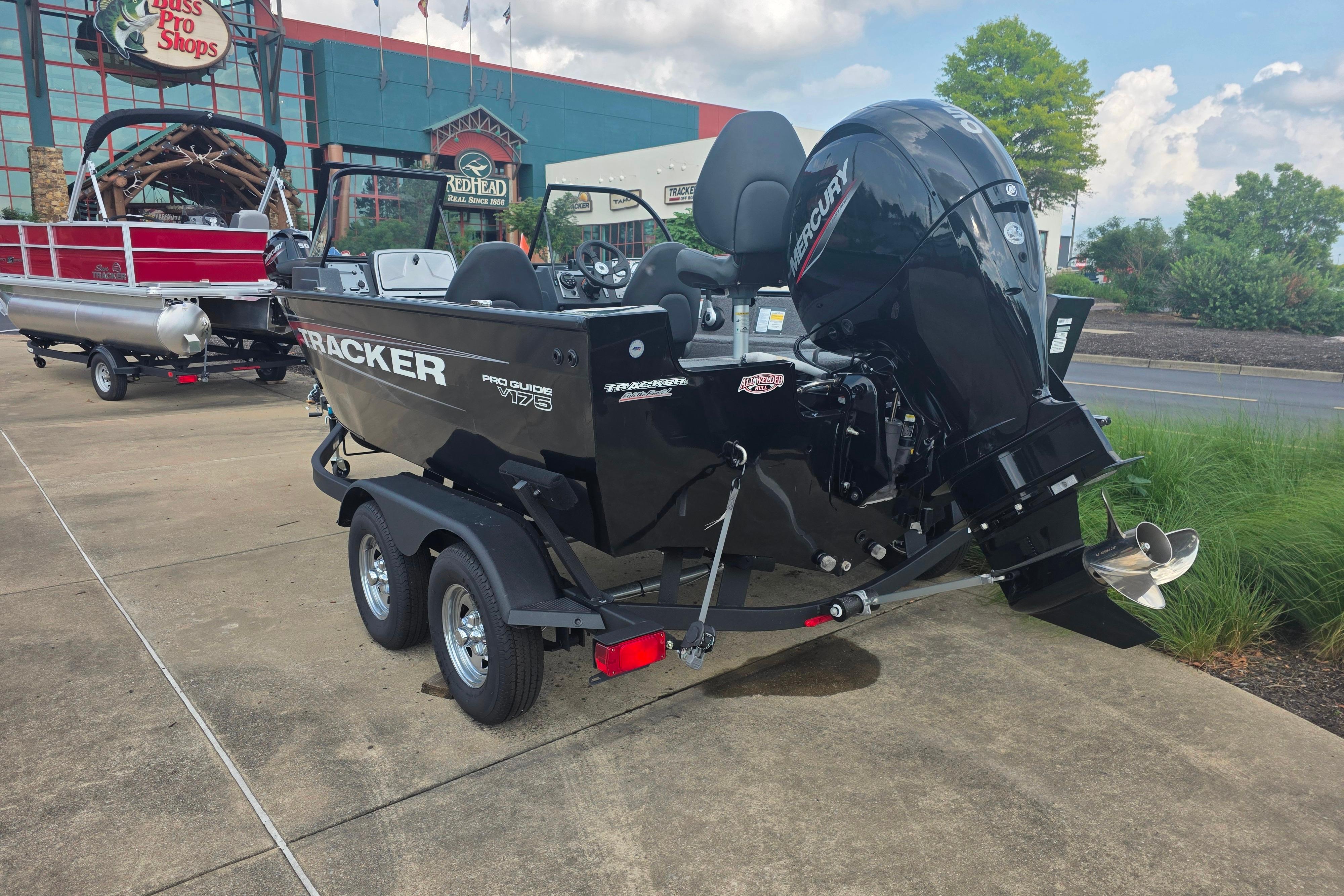 2026 Tracker Pro Guide V-175 Combo boat on trailer outside Bass Pro Shops.