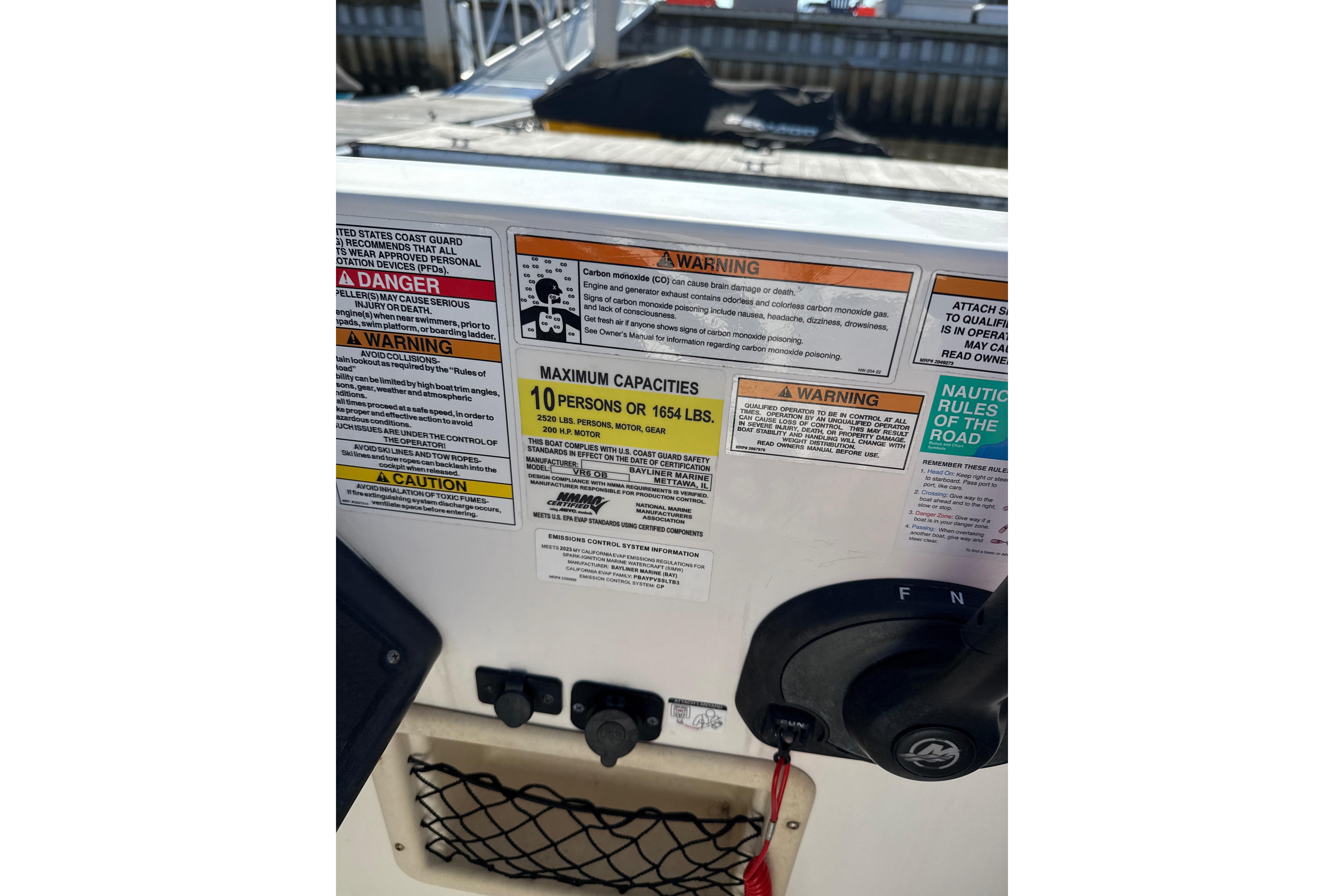 2023 Bayliner VR6 Bowrider OB safety and capacity labels, maximum 10 persons or 1654 lbs.