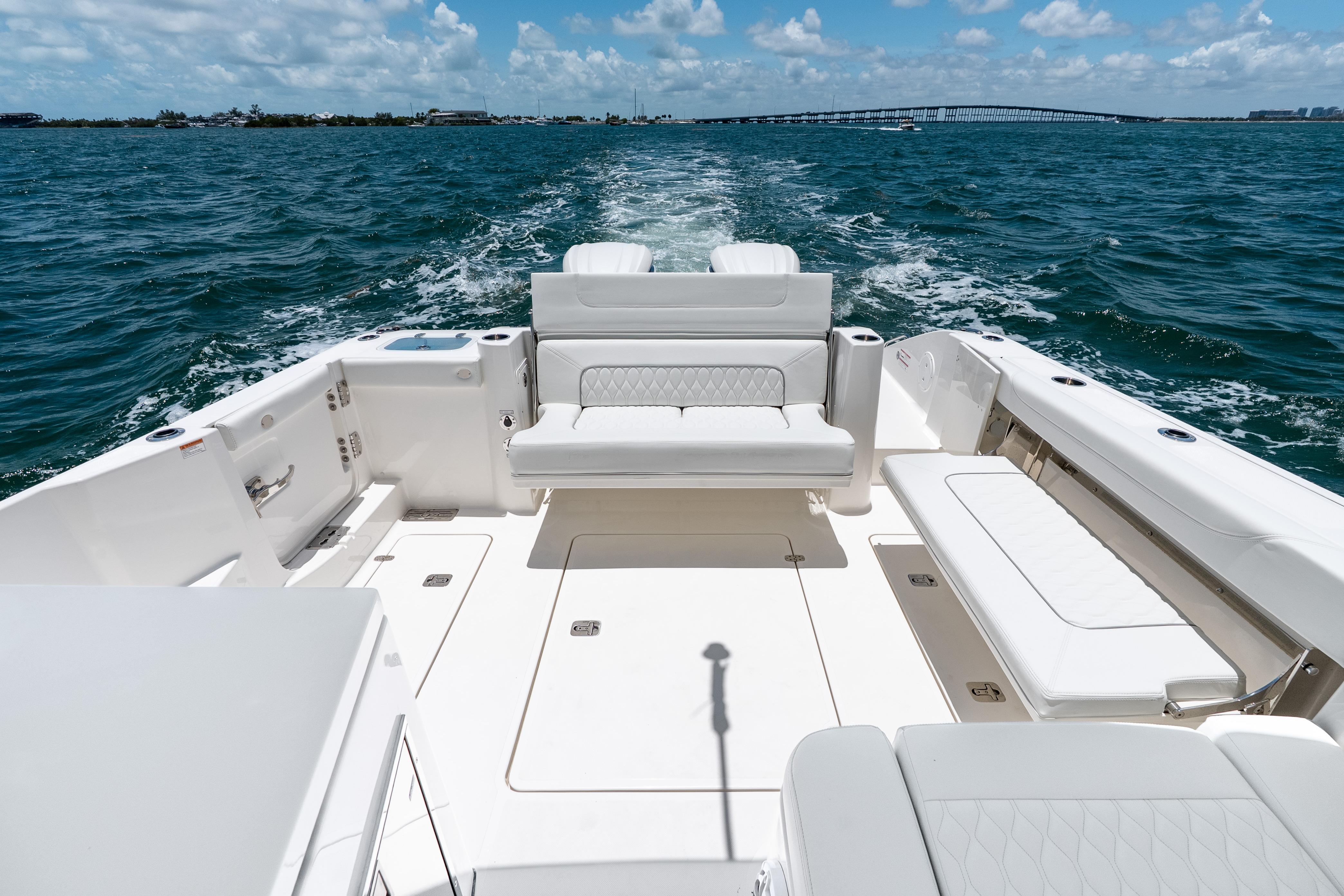 2026 Pursuit DC 326 Dual Console boat cruising on open water, featuring spacious seating.
