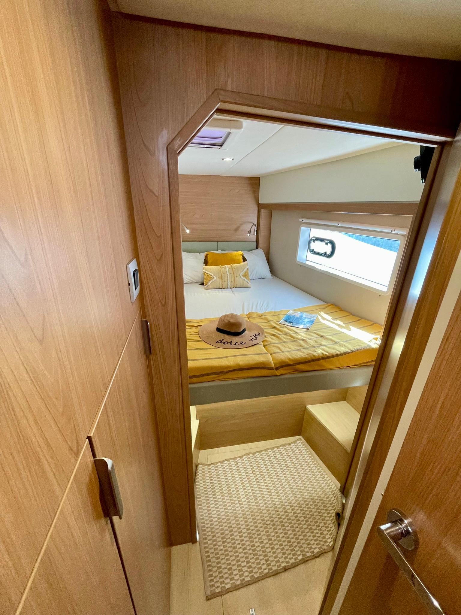 Cozy cabin interior of 2026 Bali 4.2 yacht with bed and window view.