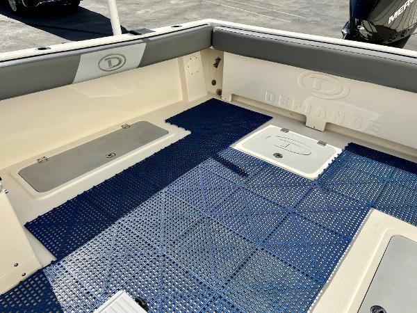 2023 Defiance Admiral 220 EX boat deck with blue non-slip flooring.