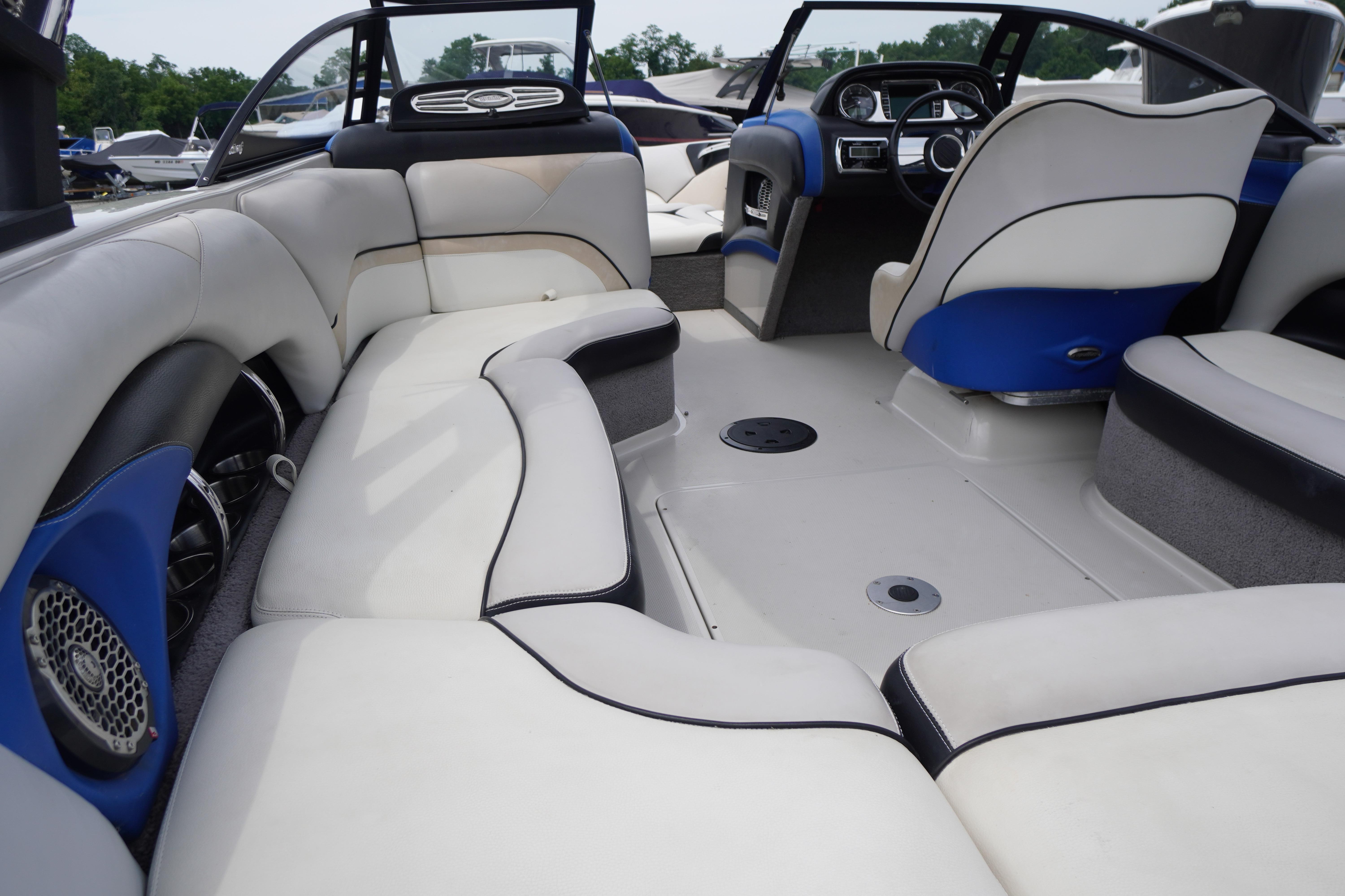 Interior of a 2011 Malibu Wakesetter 21 VLX boat with white and blue seating.