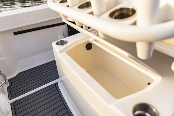 Manufacturer Provided Image: 2025 Bayliner Trophy T22CC boat interior with rod holders and storage compartment.