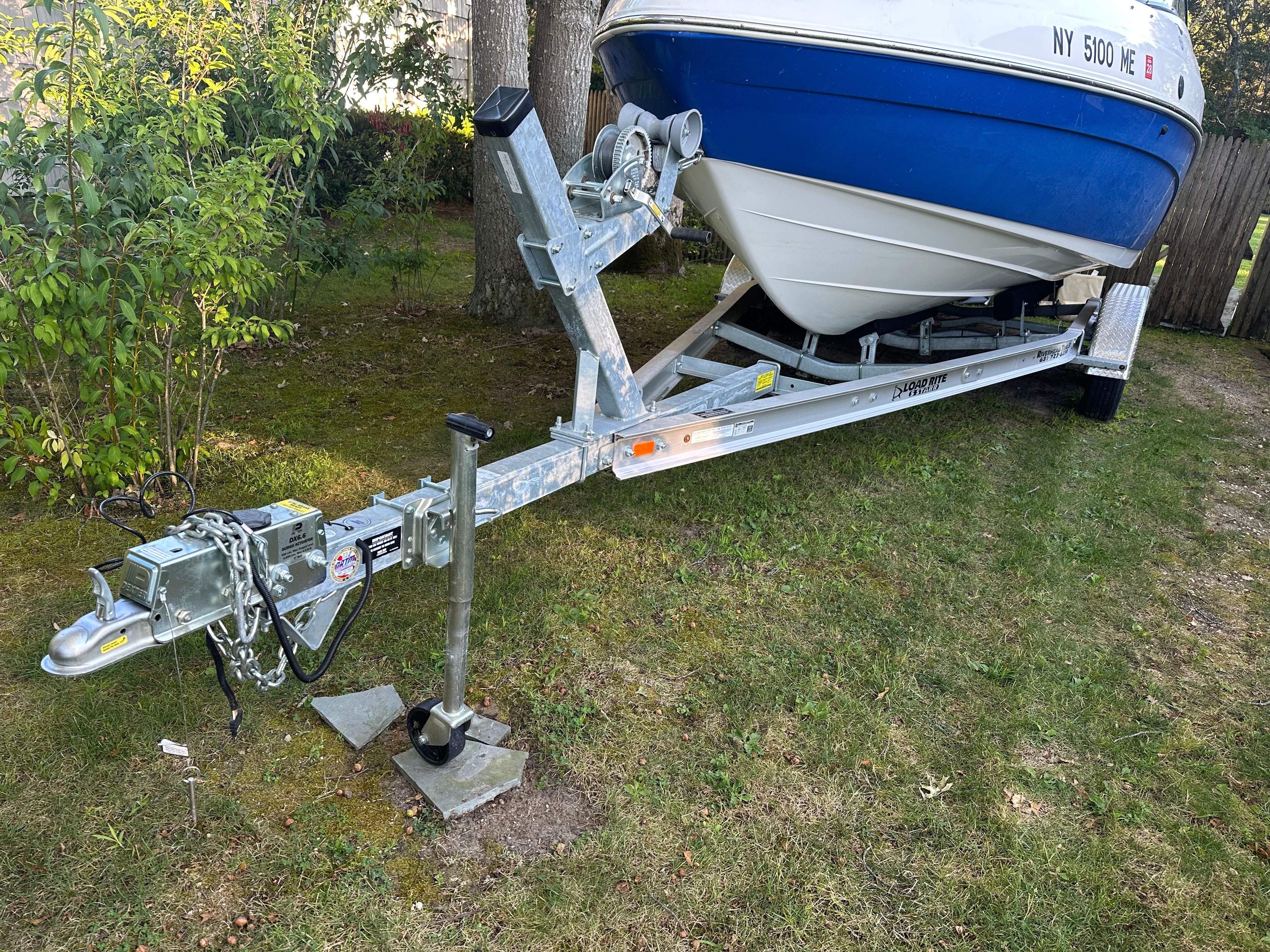 2008 Yamaha SX230 HO boat on trailer in yard.