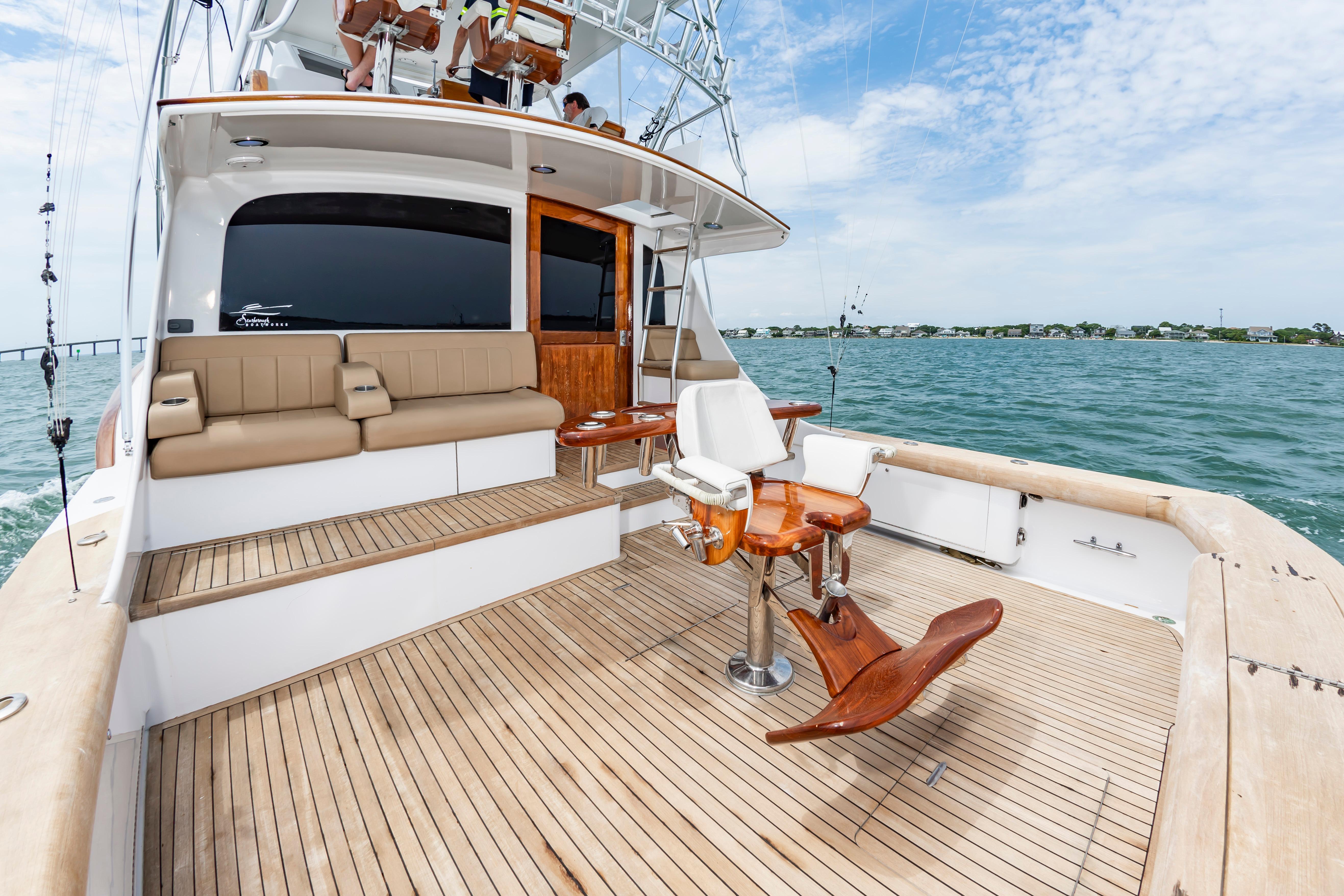Luxurious 1993 Custom Carolina Scarborough 56 Convertible yacht with spacious deck and seating.