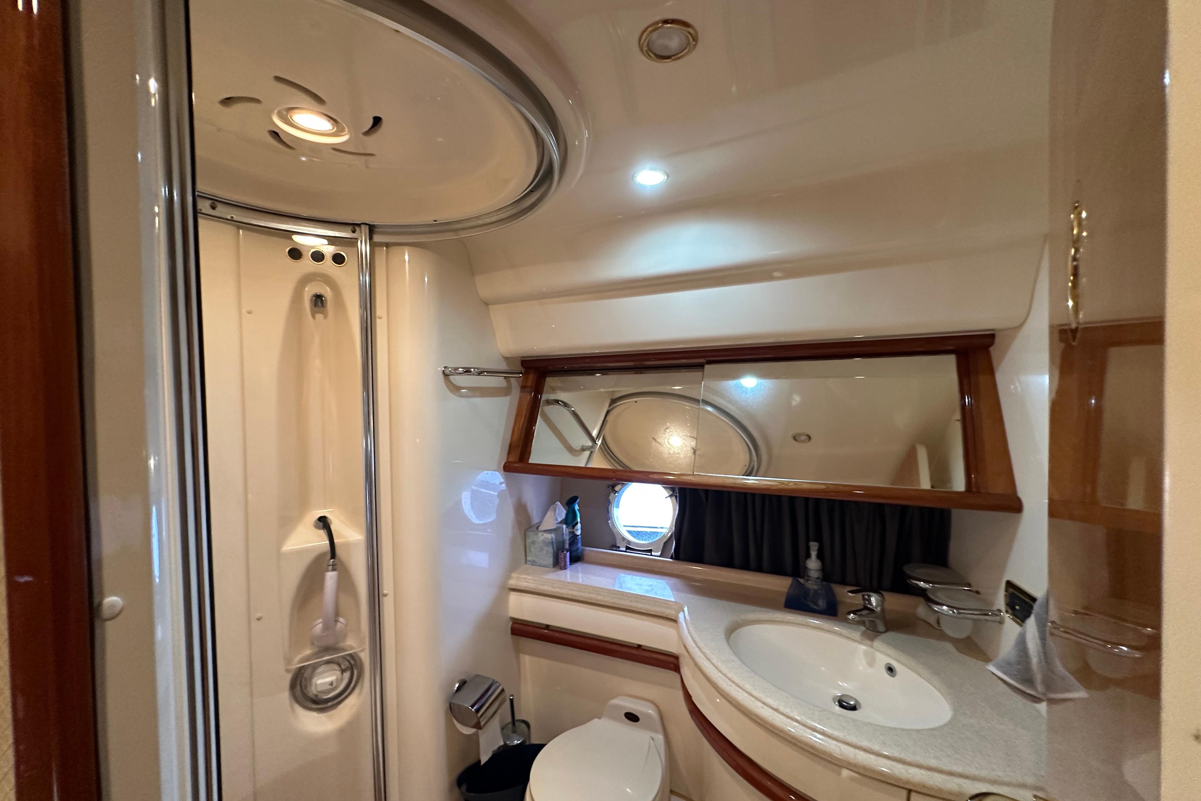 Luxurious bathroom in a 2004 Azimut 55E yacht, featuring modern fixtures and elegant design.