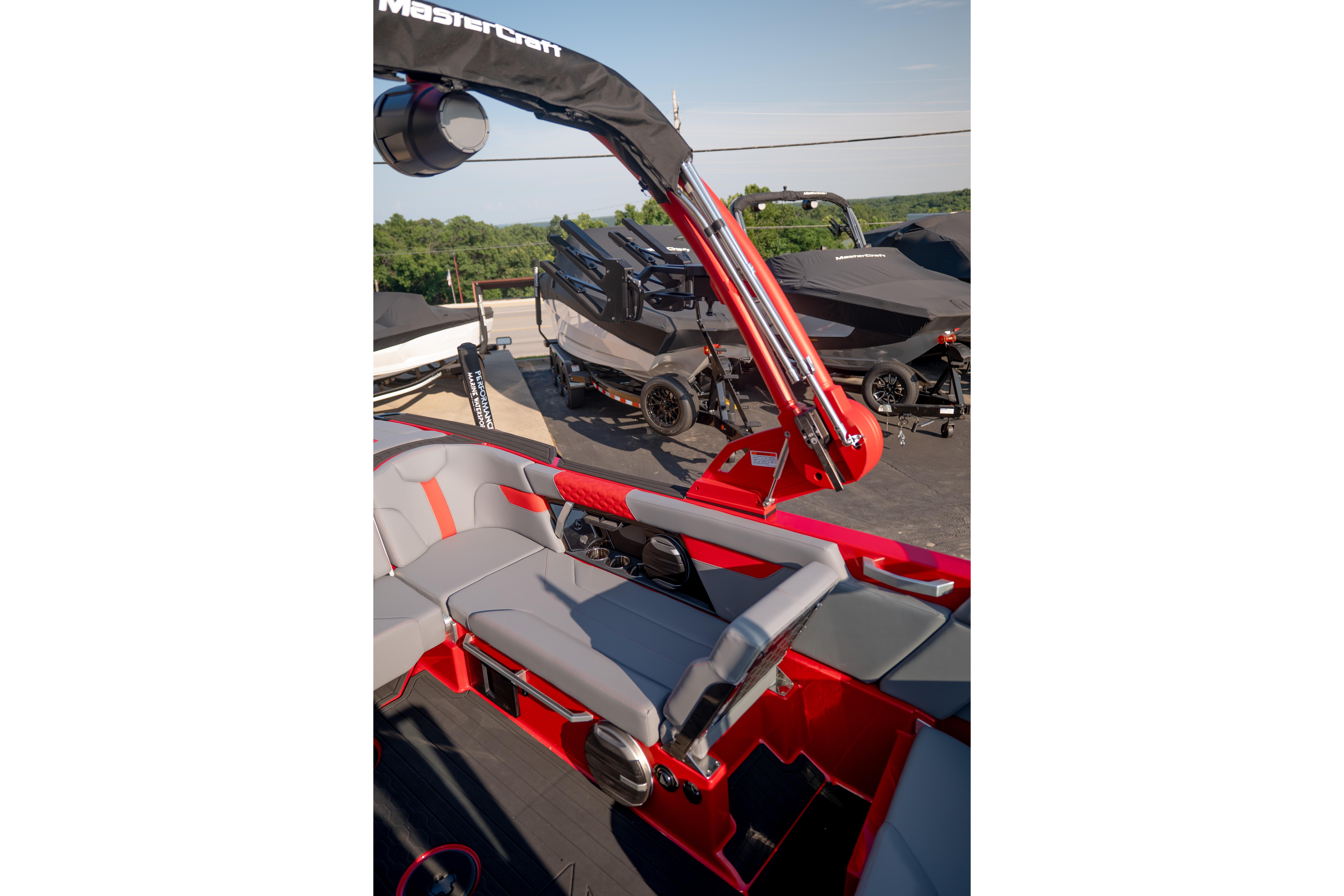 2027 MasterCraft XT24 boat interior with red and gray seating, showcasing sleek design.