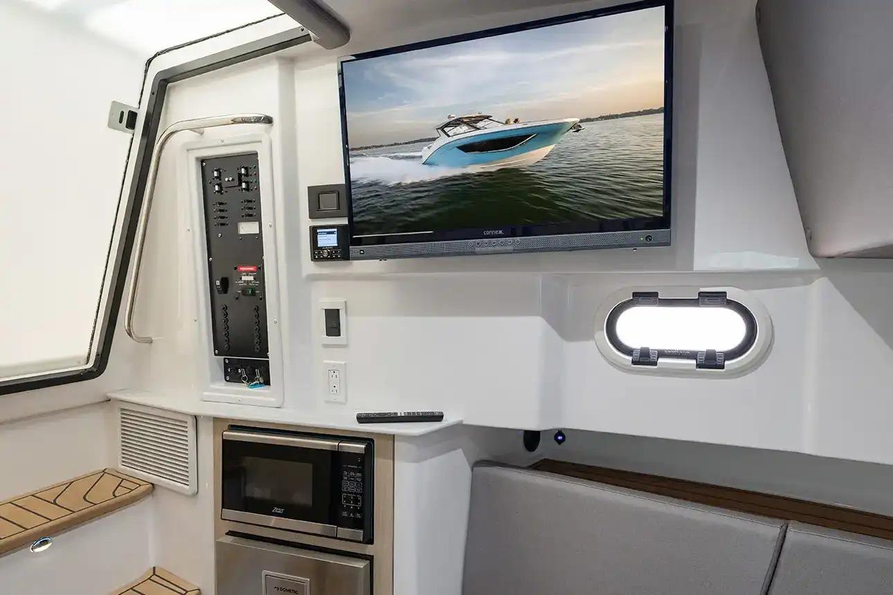 Manufacturer Provided Image: Interior of 2026 Hurricane SunDeck 3200 OB with TV, microwave, and control panel.