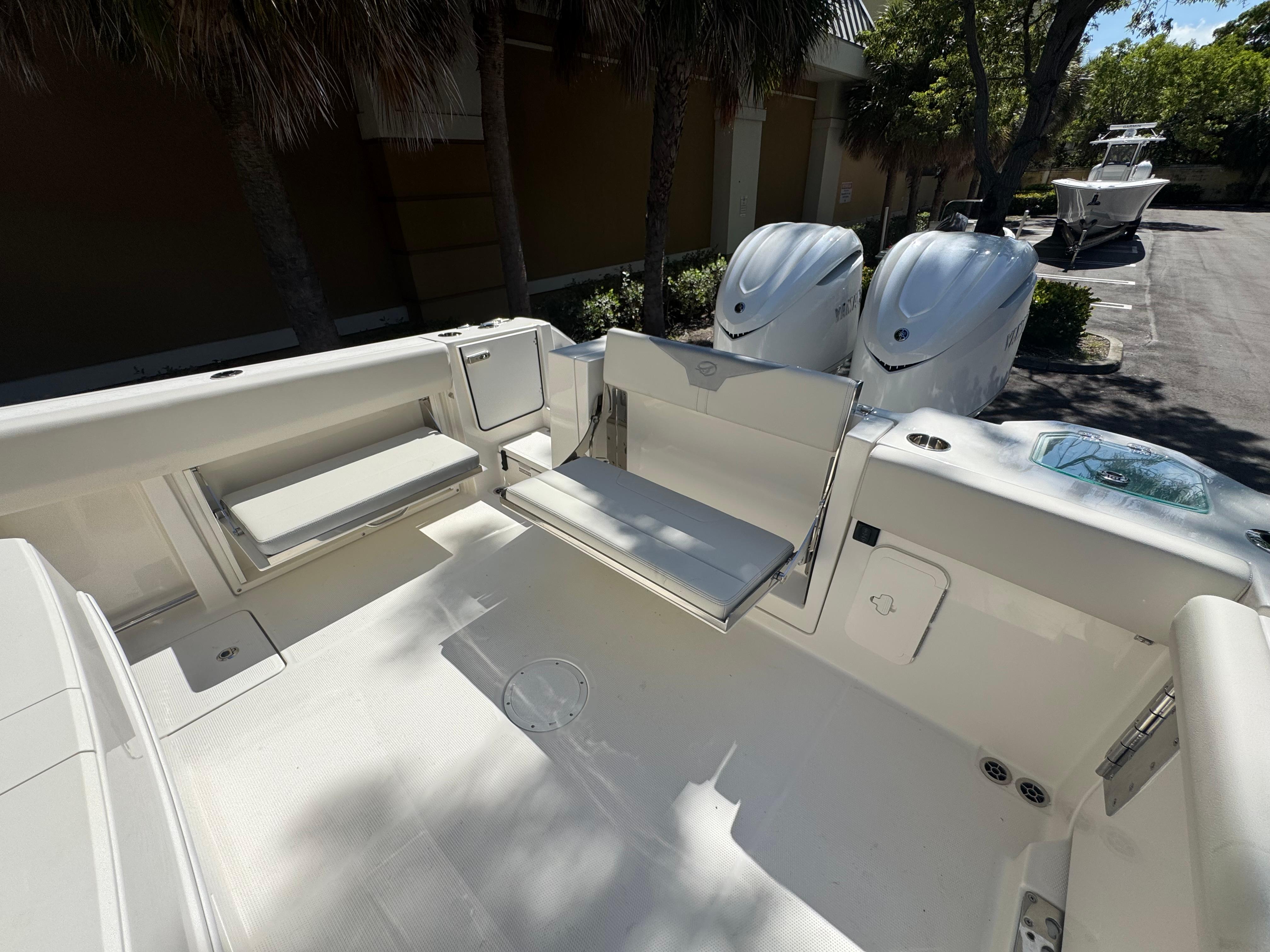 2026 Sailfish 312 CC boat interior with foldable seating and twin outboard engines.