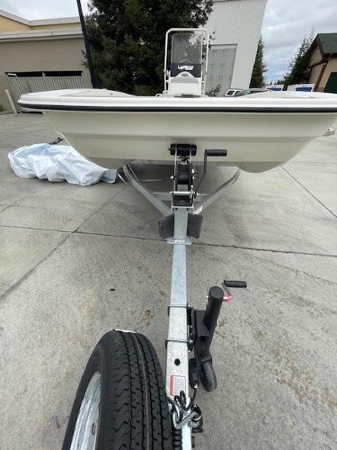 2025 Mako Pro Skiff 17 CC boat on trailer, parked outdoors.