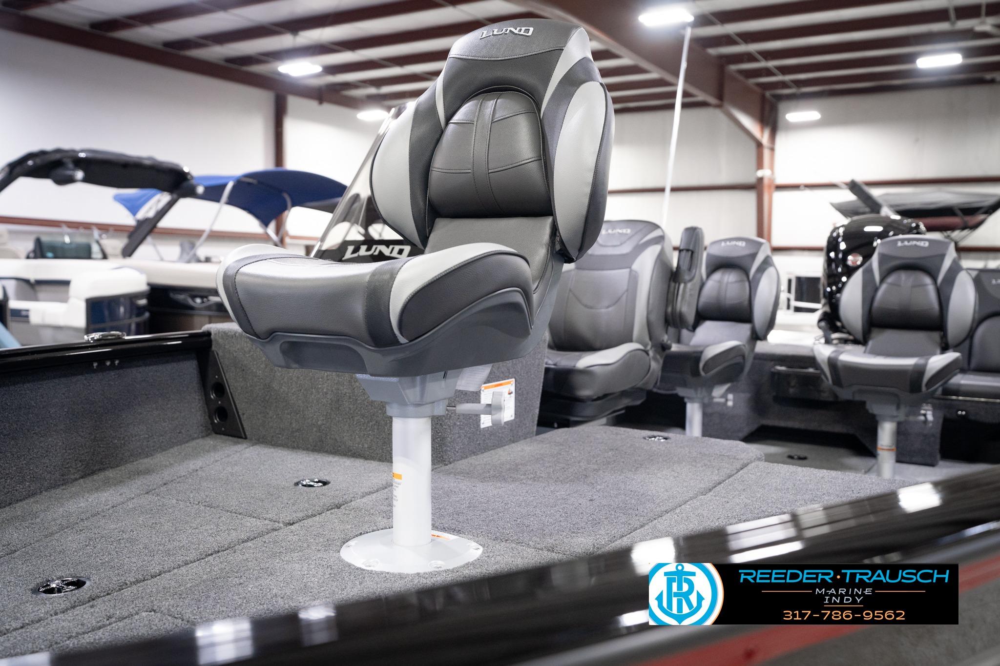 2026 Lund 1775 Impact XS SS boat interior with premium seating in showroom.