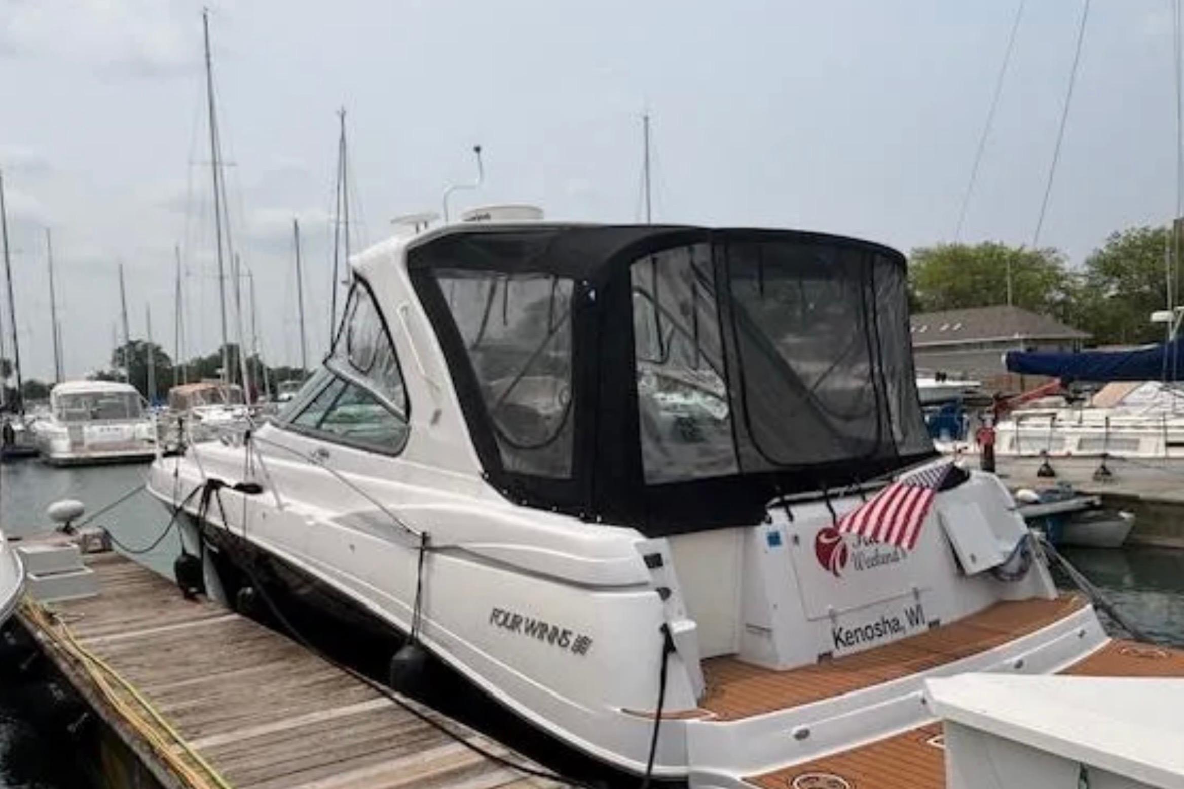 2007 Four Winns 378 Vista yacht docked at a marina with American flag.