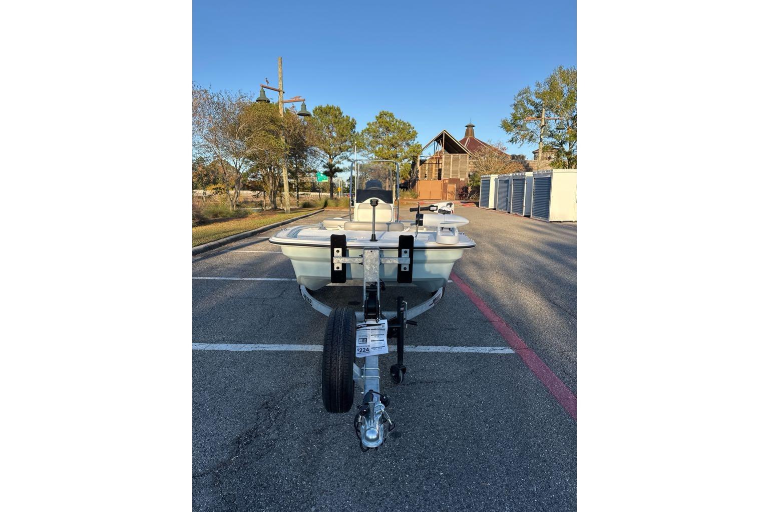 2026 Mako Pro Skiff 13 CC boat on trailer in parking lot.