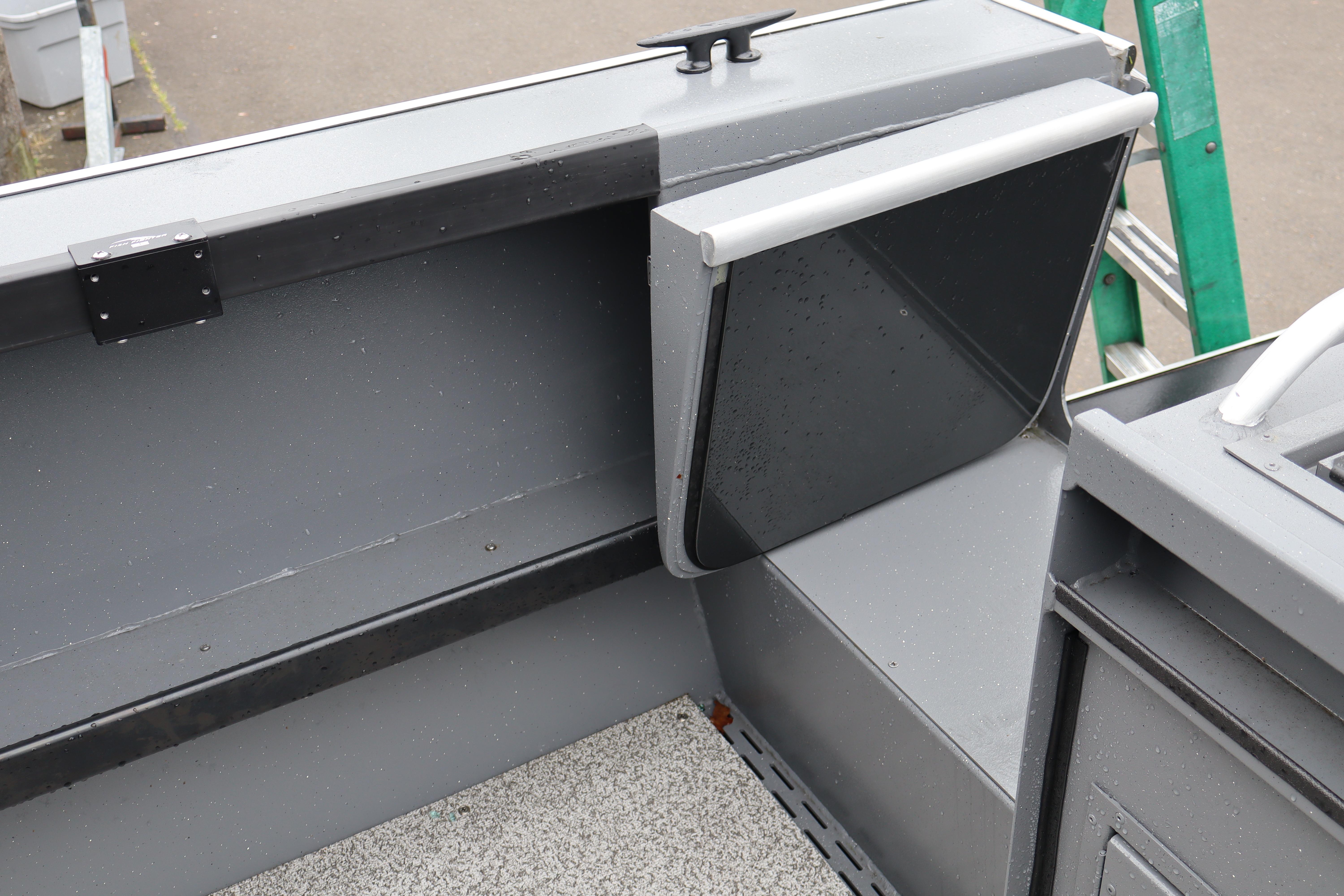 2026 Alumaweld Horizon 24 boat interior detail with storage compartment and gray finish.