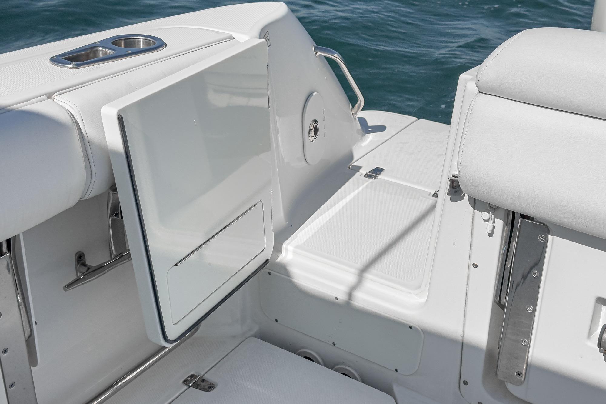 2015 Boston Whaler 370 Outrage boat interior with white seating and storage compartment.