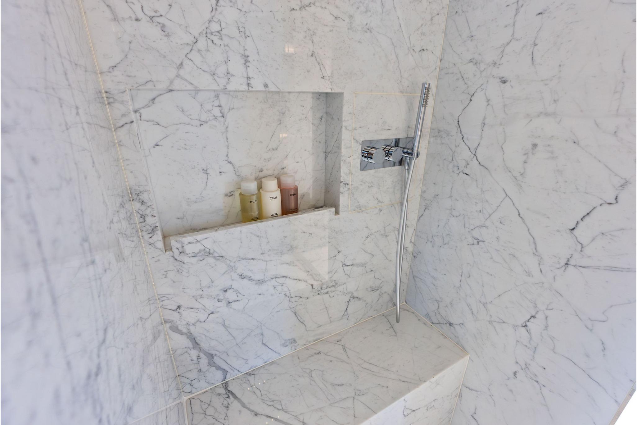 Luxurious marble shower in 2024 Riva 130' Bellissima yacht bathroom.