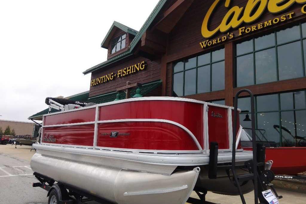 2026 Sun Tracker Party Barge 16 DLX pontoon boat outside Cabela's store.