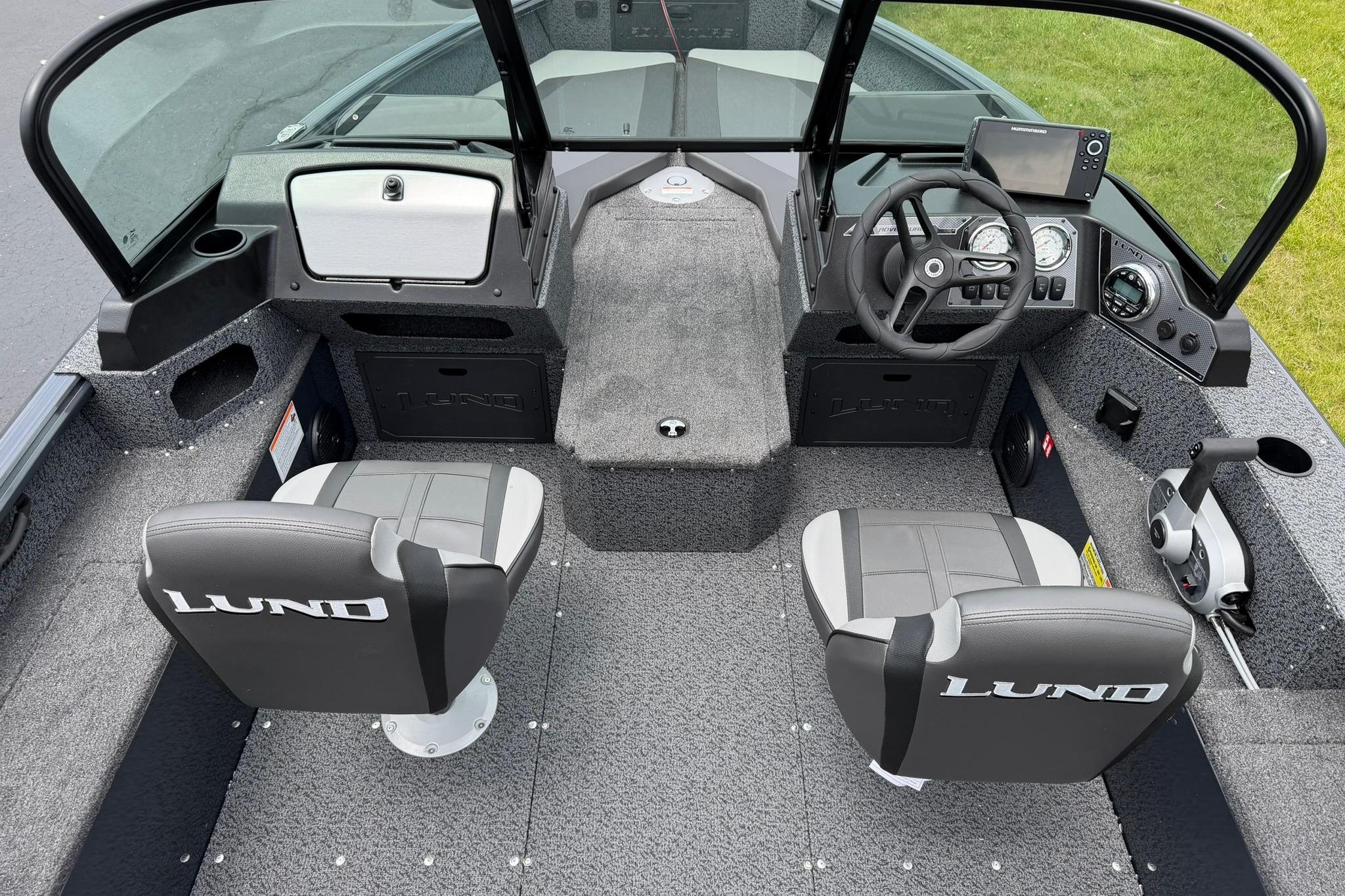 Interior of 2027 Lund 1675 Adventure Sport boat with steering console and seating.