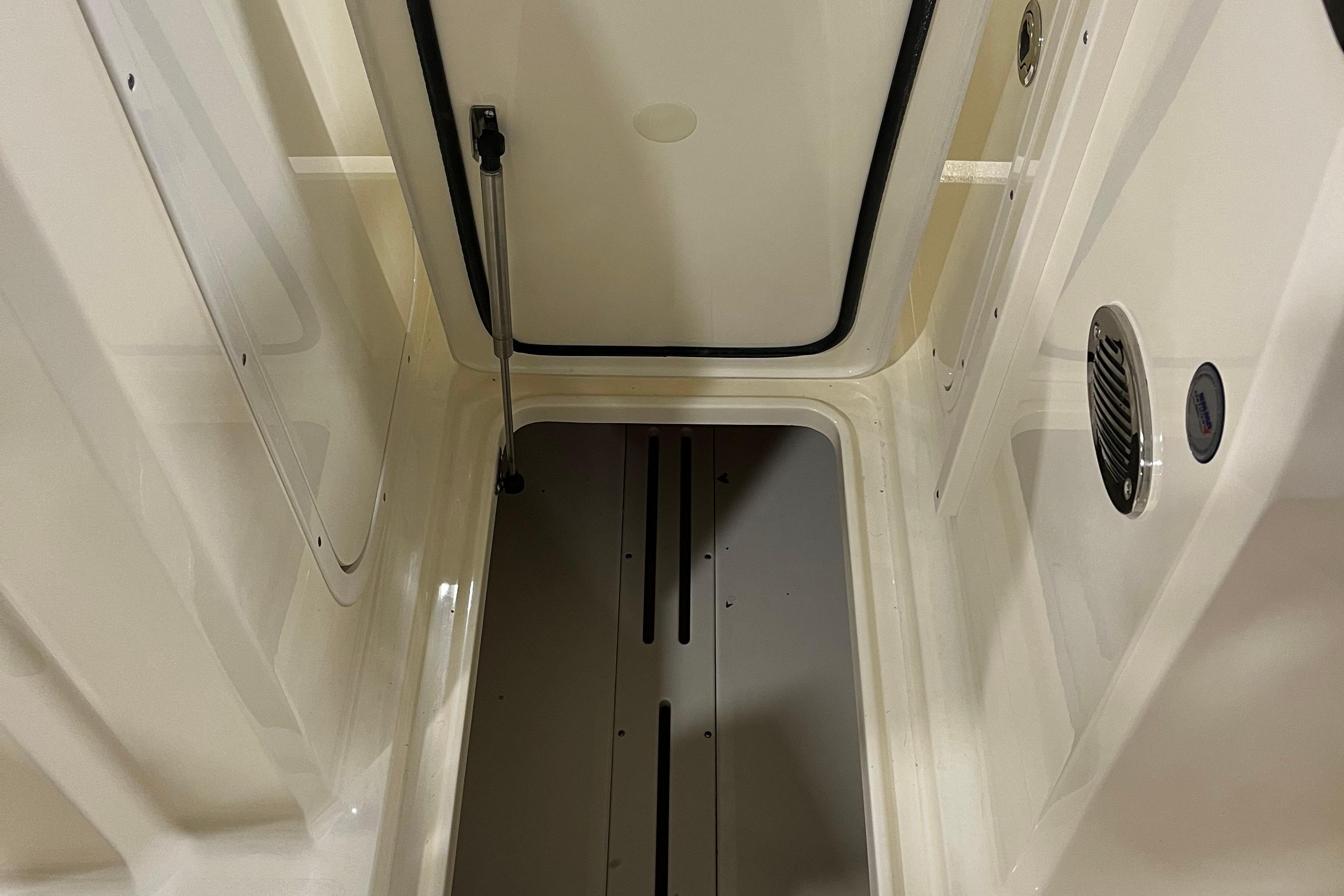 Interior view of 2025 Scout 215 Dorado boat compartment, featuring sleek design and storage space.