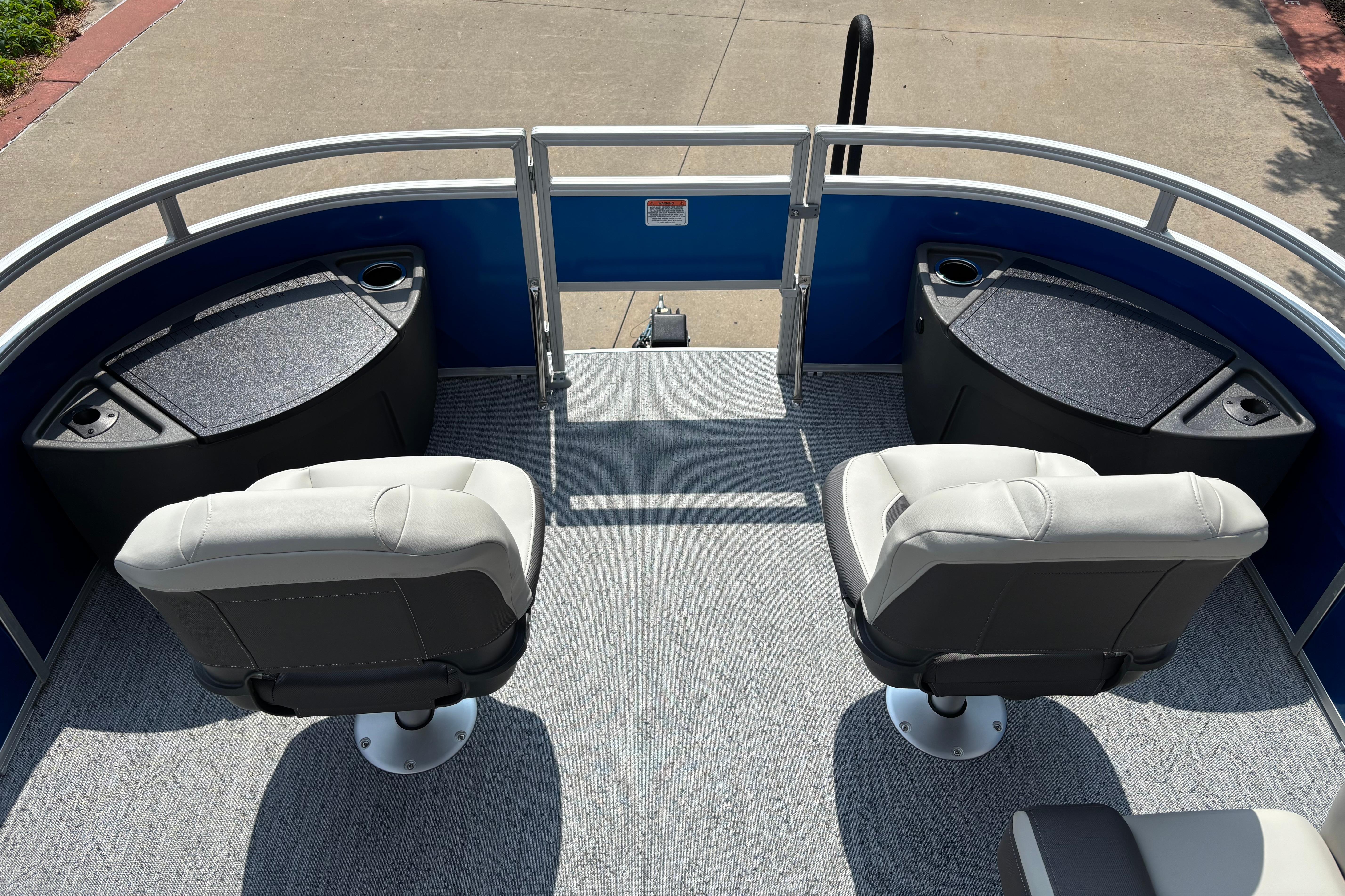 2026 Sun Tracker Fishin' Barge 20 DLX with two swivel seats and storage compartments.