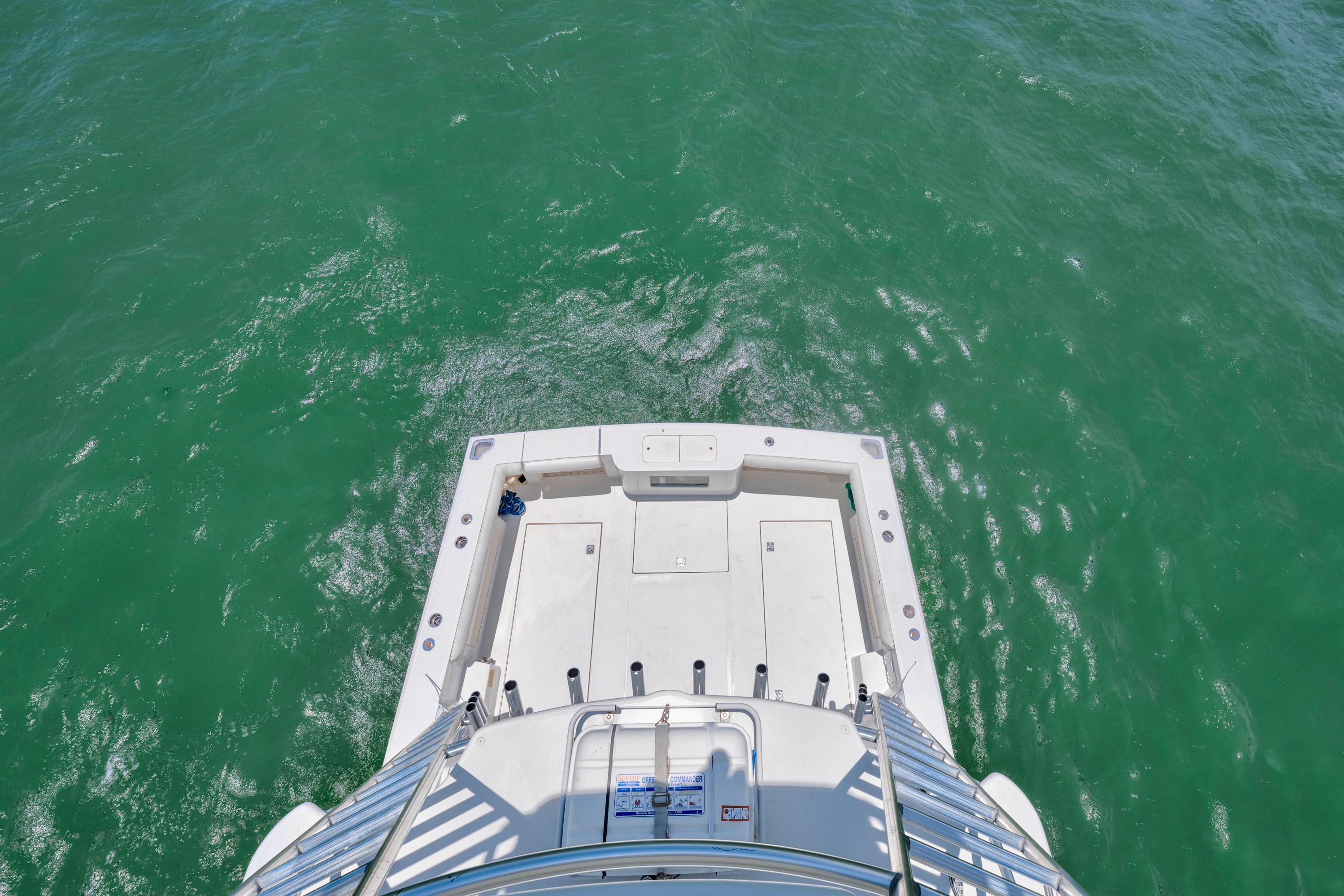 Aerial view of 2010 Cabo 45 Express boat deck on turquoise water.