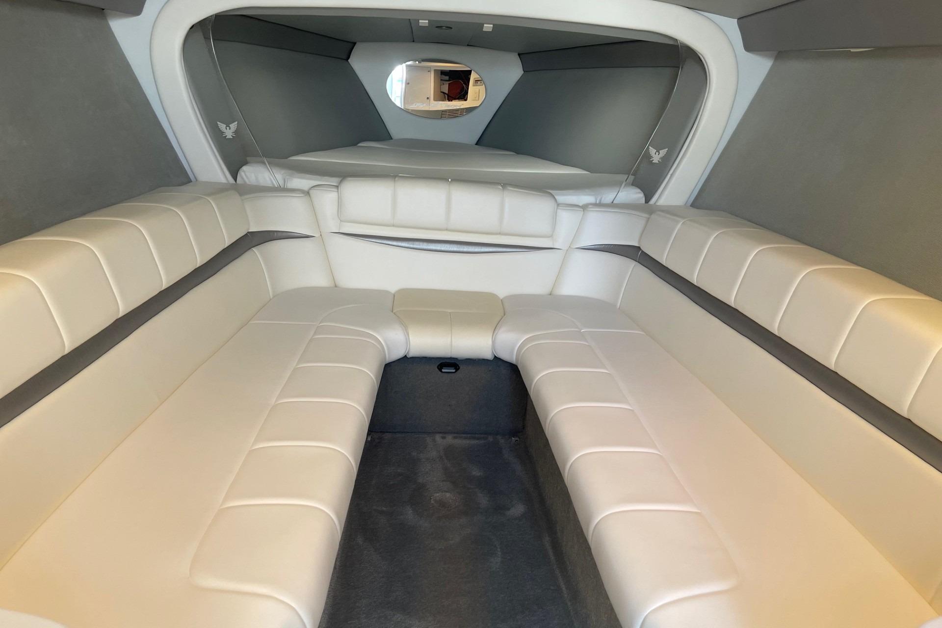 2004 Formula 382 FASTech cabin interior with white leather seating and modern design.