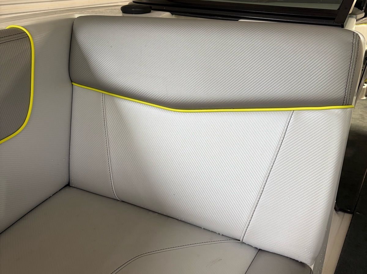 Close-up of gray boat upholstery with yellow accents.