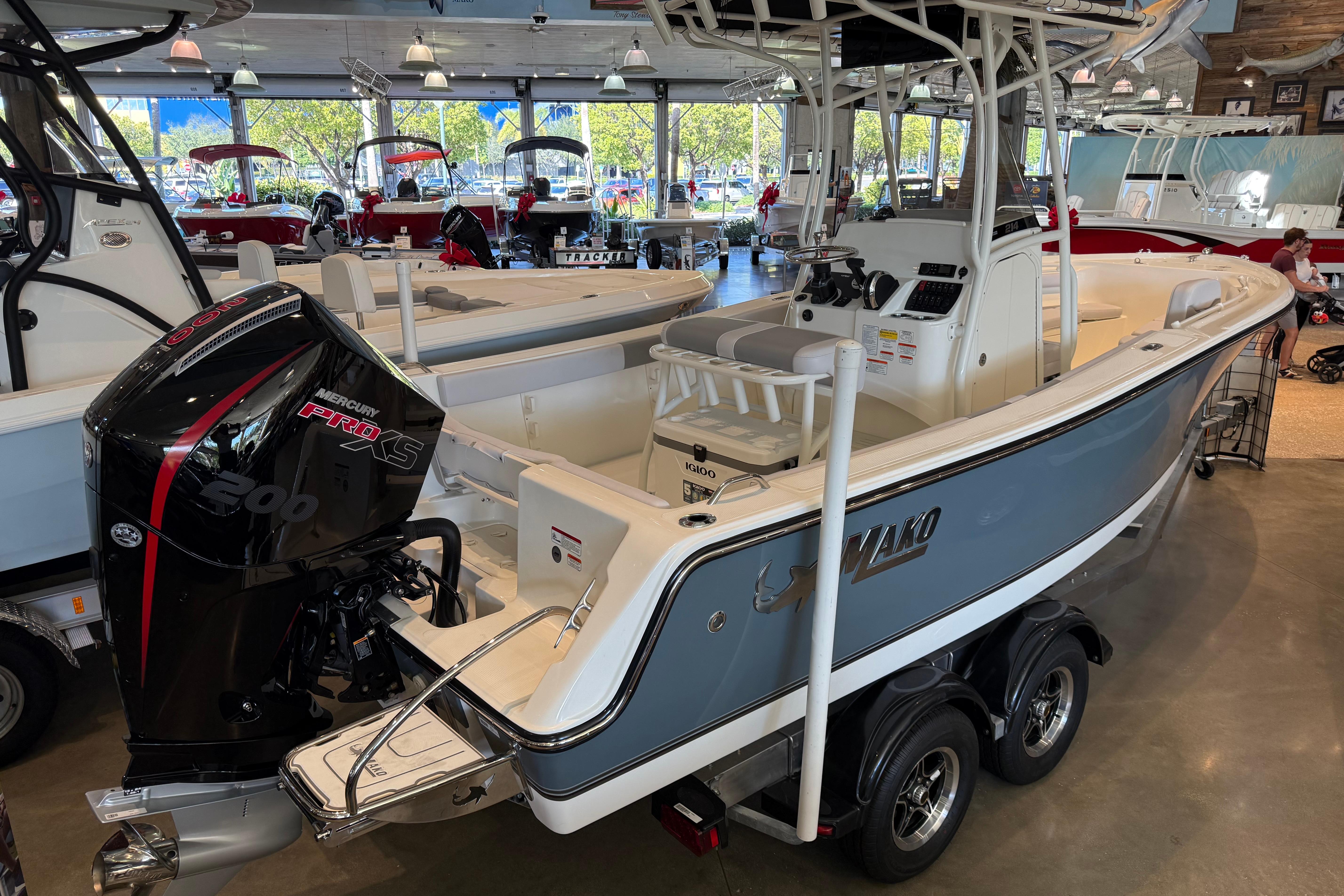 2026 Mako 214 Center Console boat with Mercury Pro XS engine in showroom.