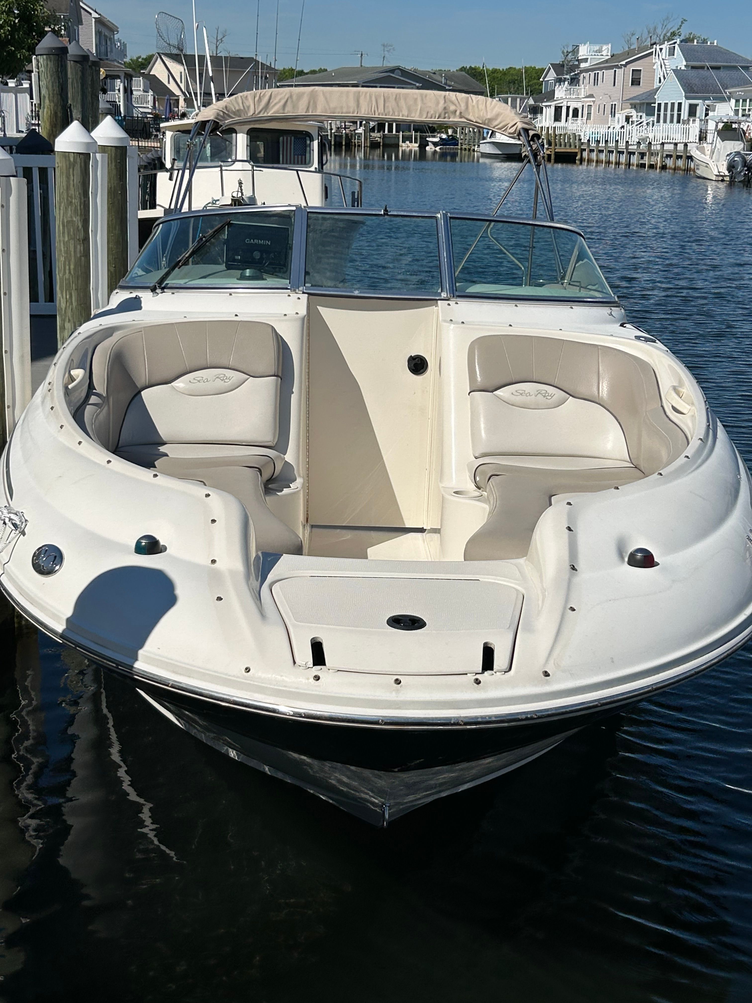 2003 Sea Ray 240 Sundeck boat docked on water.