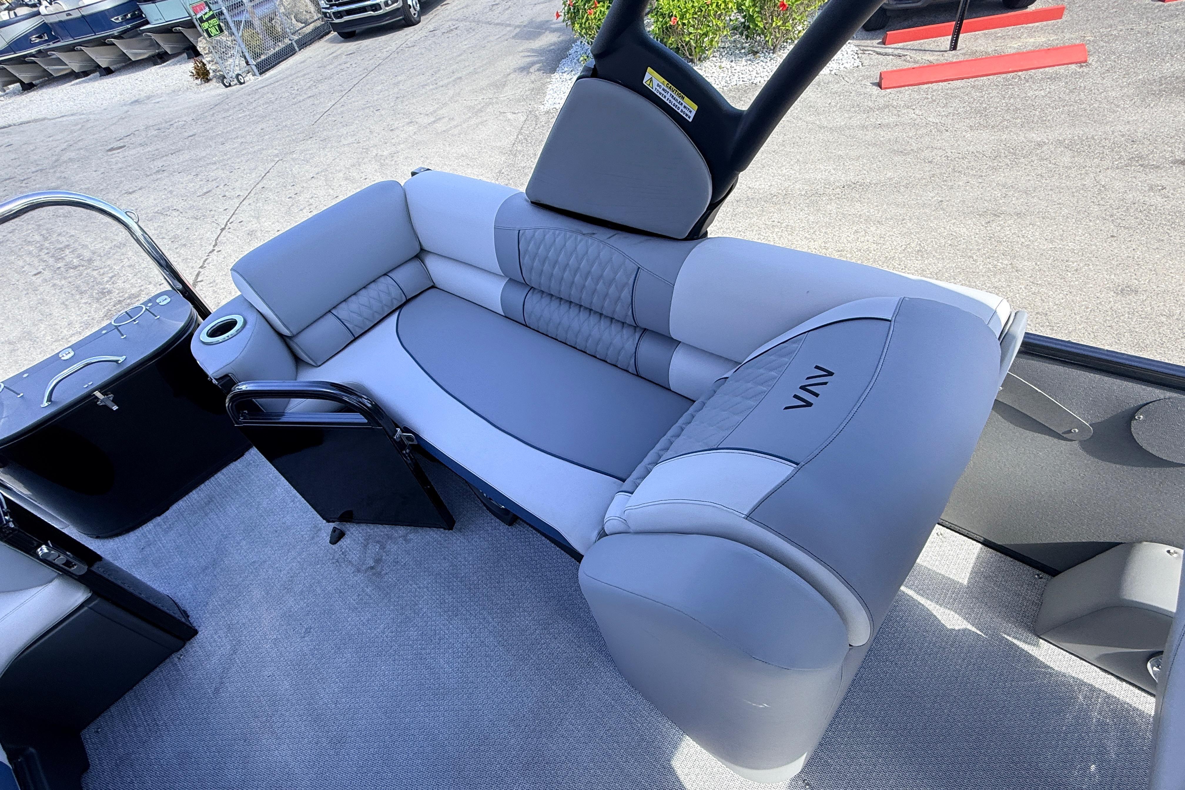 2026 Avalon 2385 Catalina Quad Lounger interior with gray seating and cup holder.