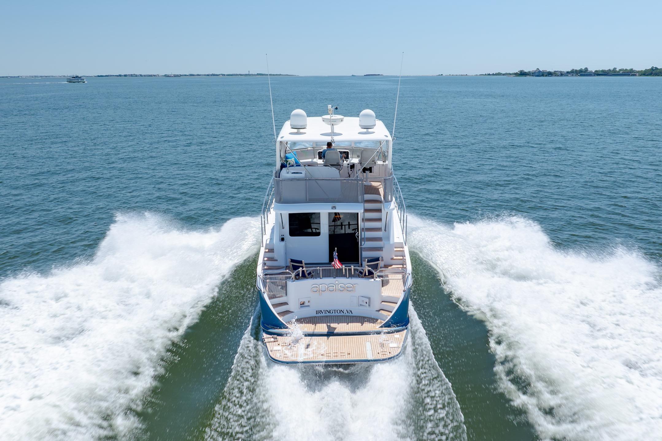 Ocean Alexander yacht cruising on open water, leaving a wake behind.