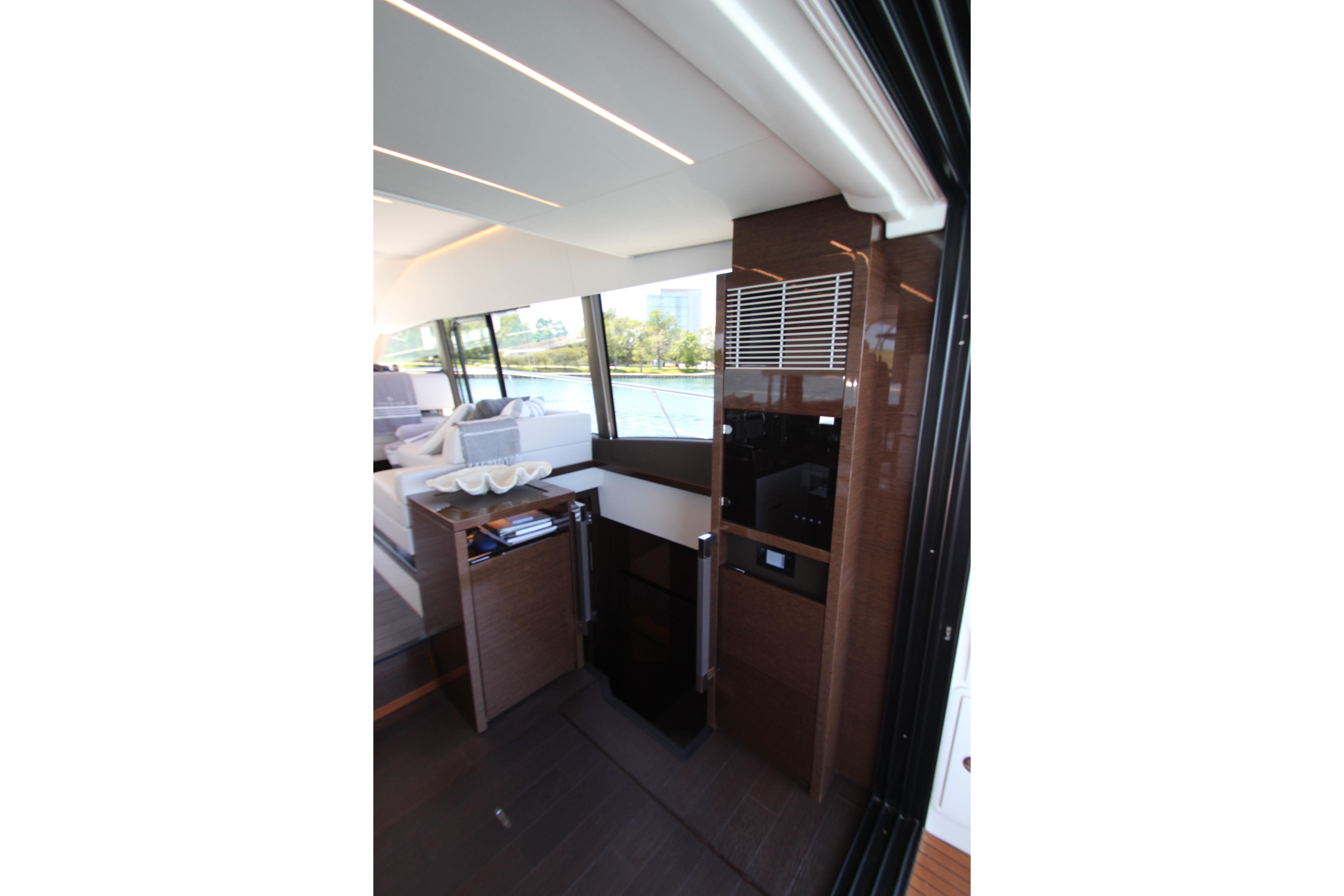 Luxurious interior of 2022 Prestige 520 yacht with modern design and large windows.