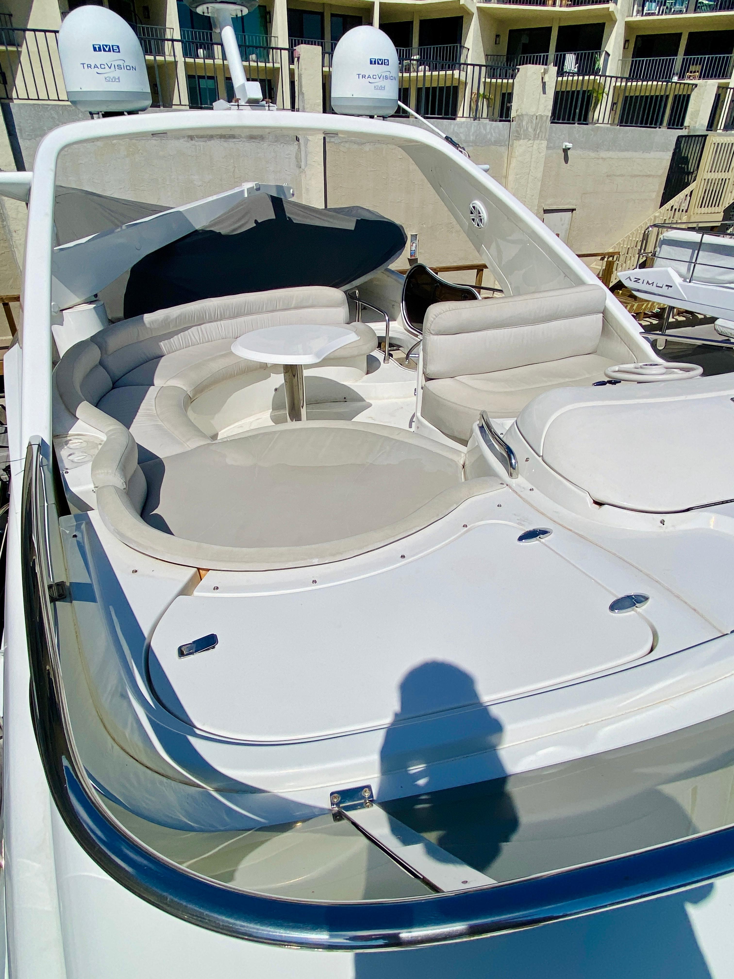 2002 Azimut 55 yacht with spacious deck seating and table.