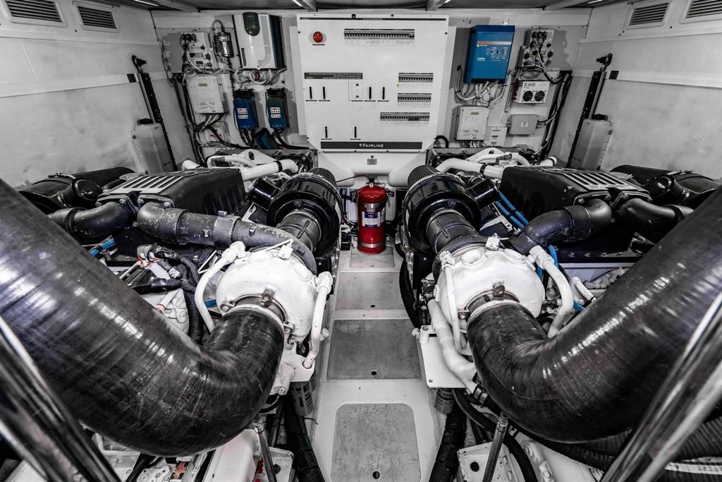 Engine room of a 2020 Fairline 68 yacht, featuring dual engines and control systems.