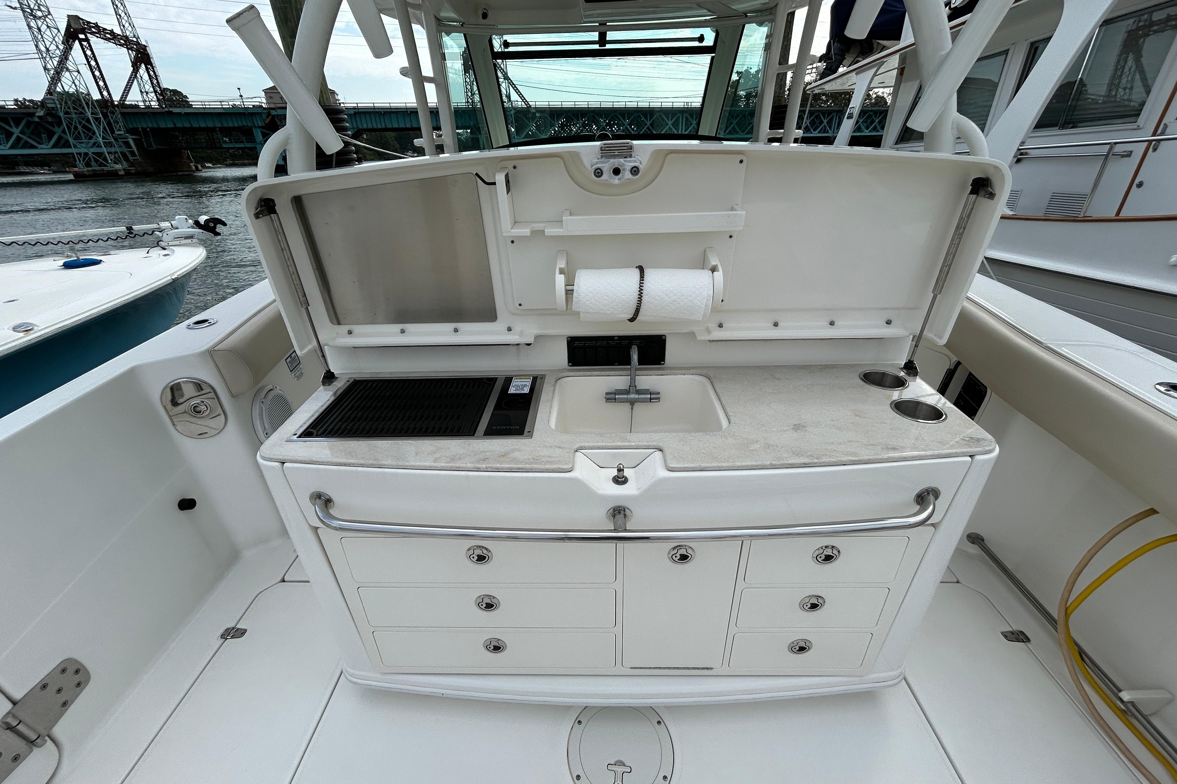 2017 Boston Whaler 370 Outrage boat with onboard kitchenette and storage drawers.
