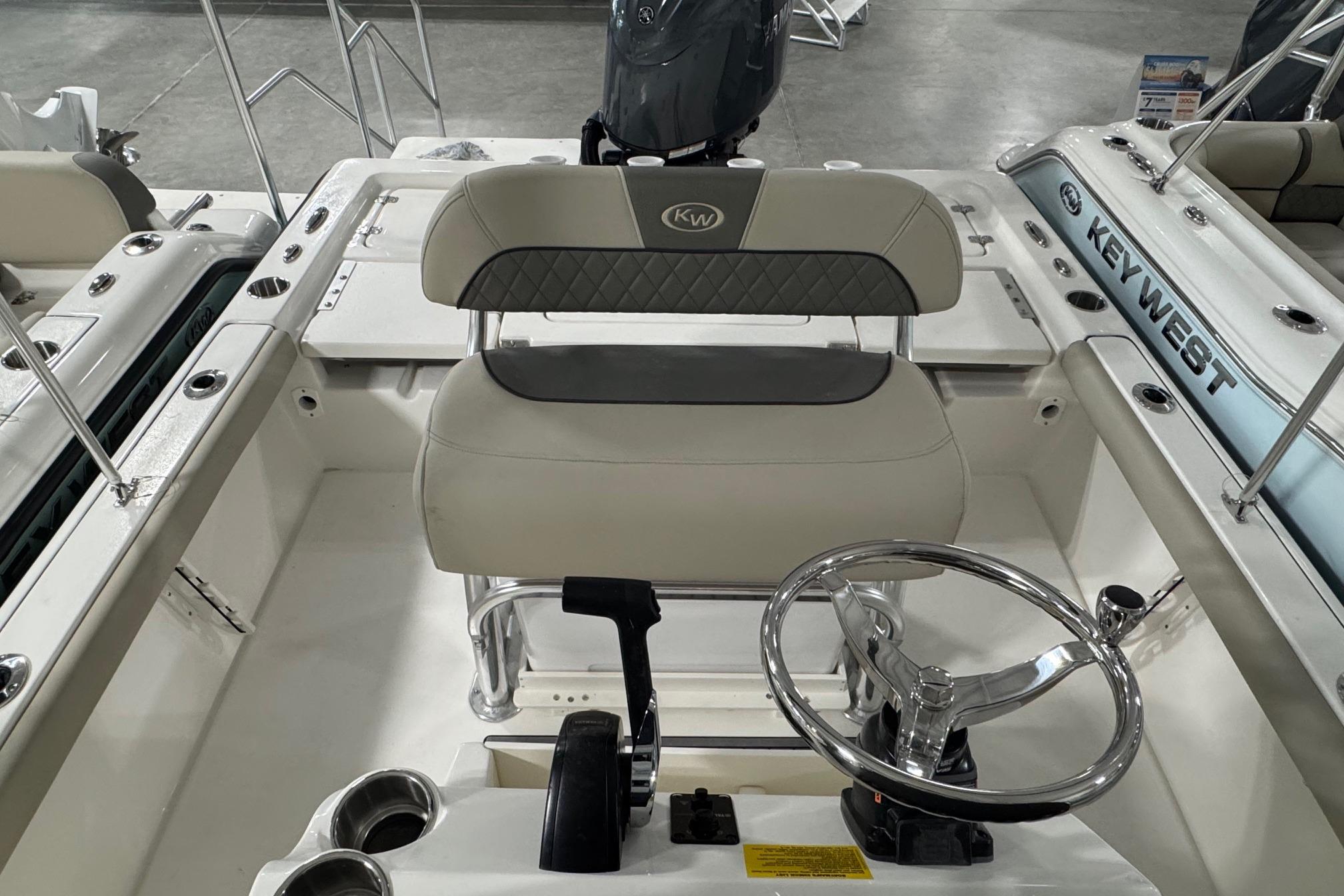 2026 Key West 210 Bay Reef boat interior with steering wheel and seating.