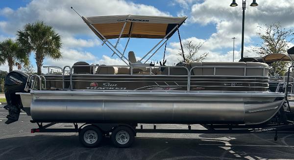 2023 Sun Tracker SportFish 22 XP3 pontoon boat with canopy on trailer.